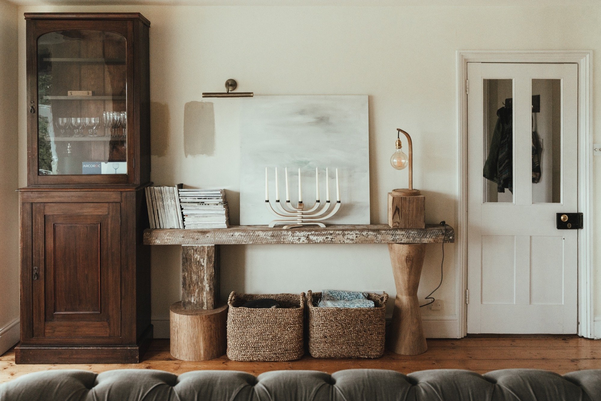 Living room with large console table made from sculpted timber blocks and salvaged beams.