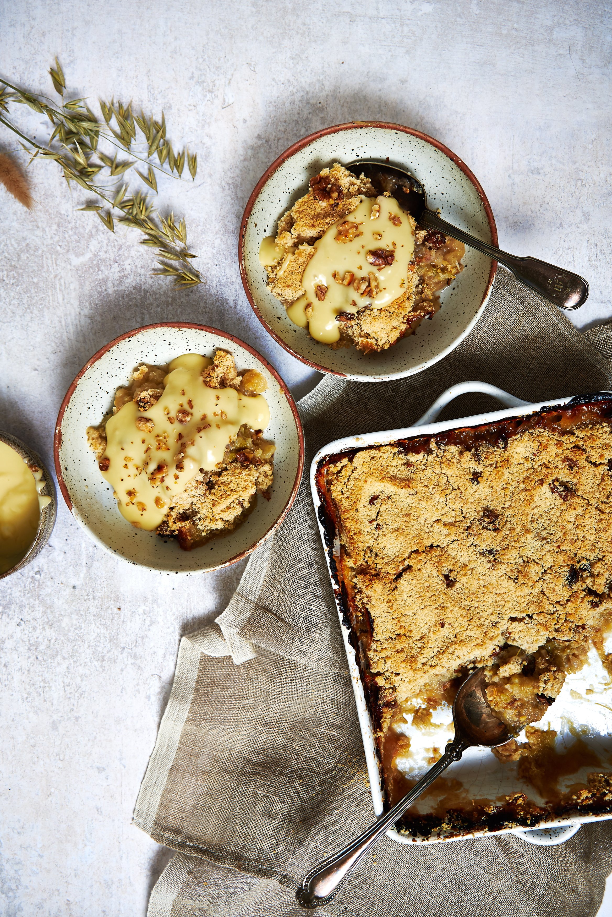 Rhubard and apple crumble in baking dish and bowls