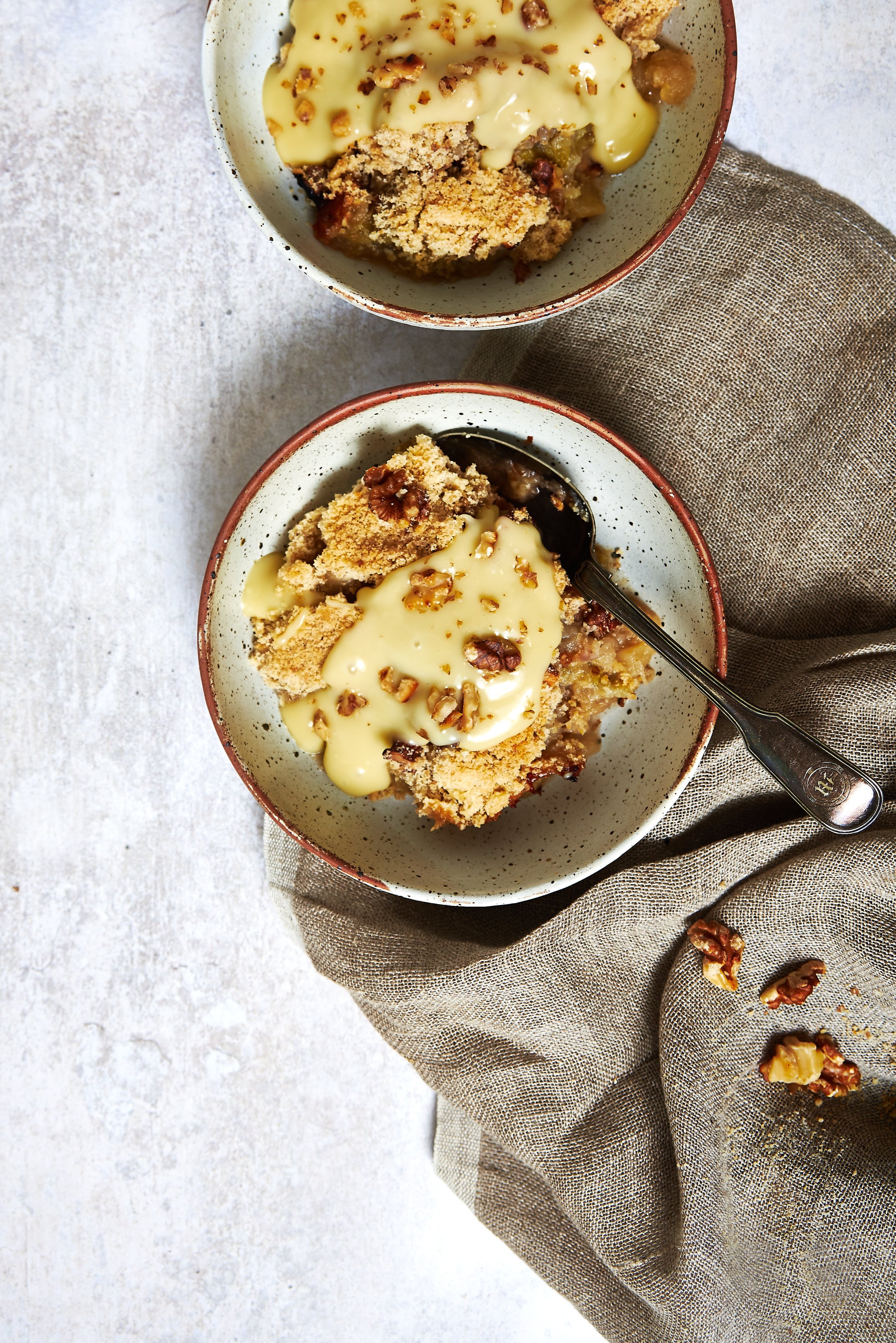Rhubarb and Apple Crumble in bowls with custard