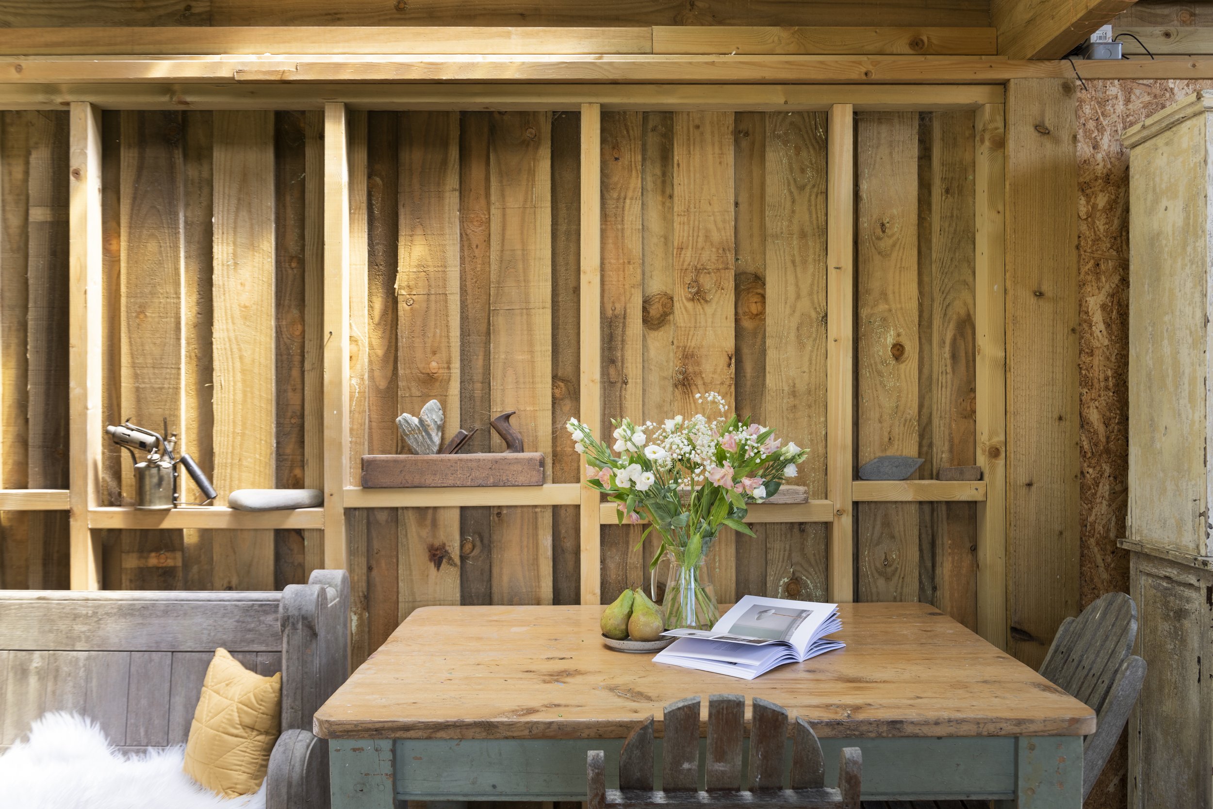 interior of a wooden clad cabin with kitchen table