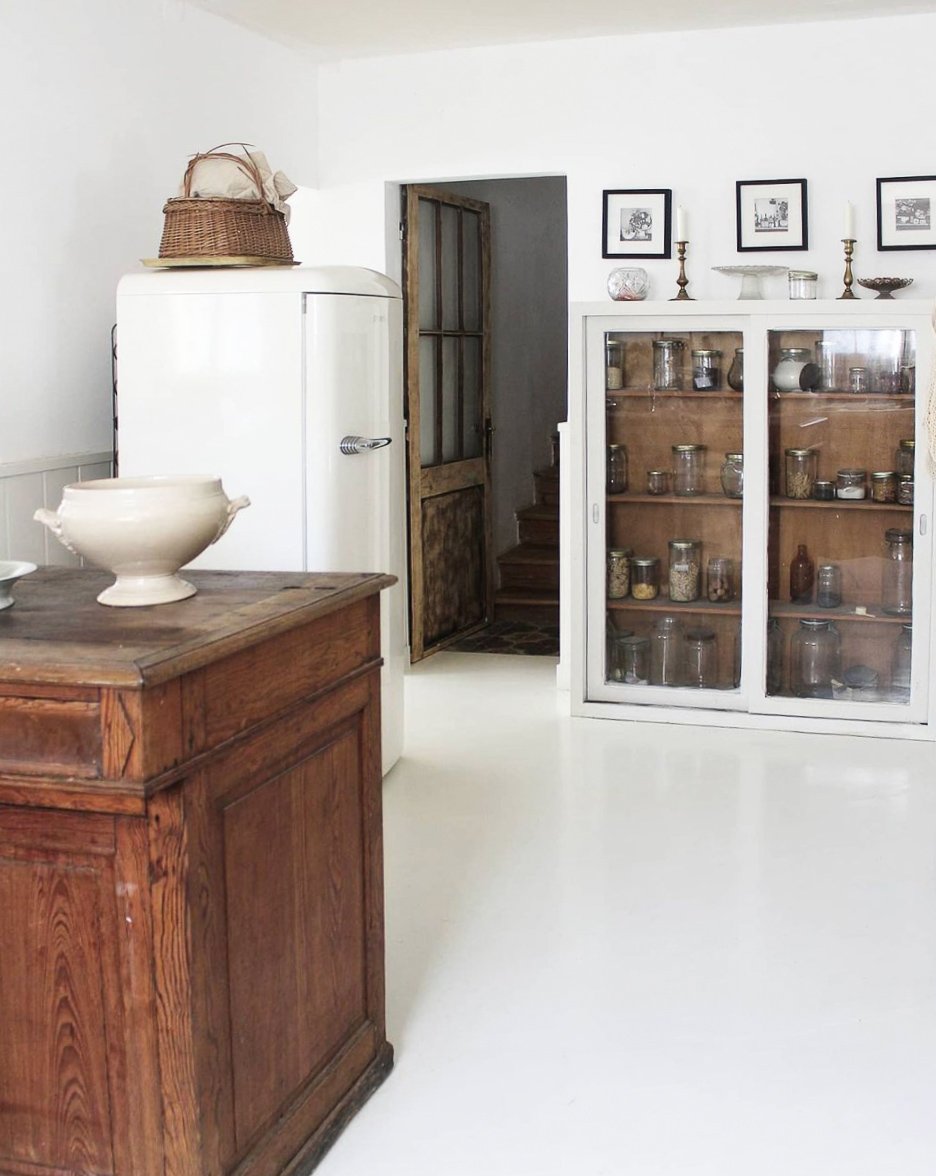 White interior of a kitchen with vintage glass fronted cabinet