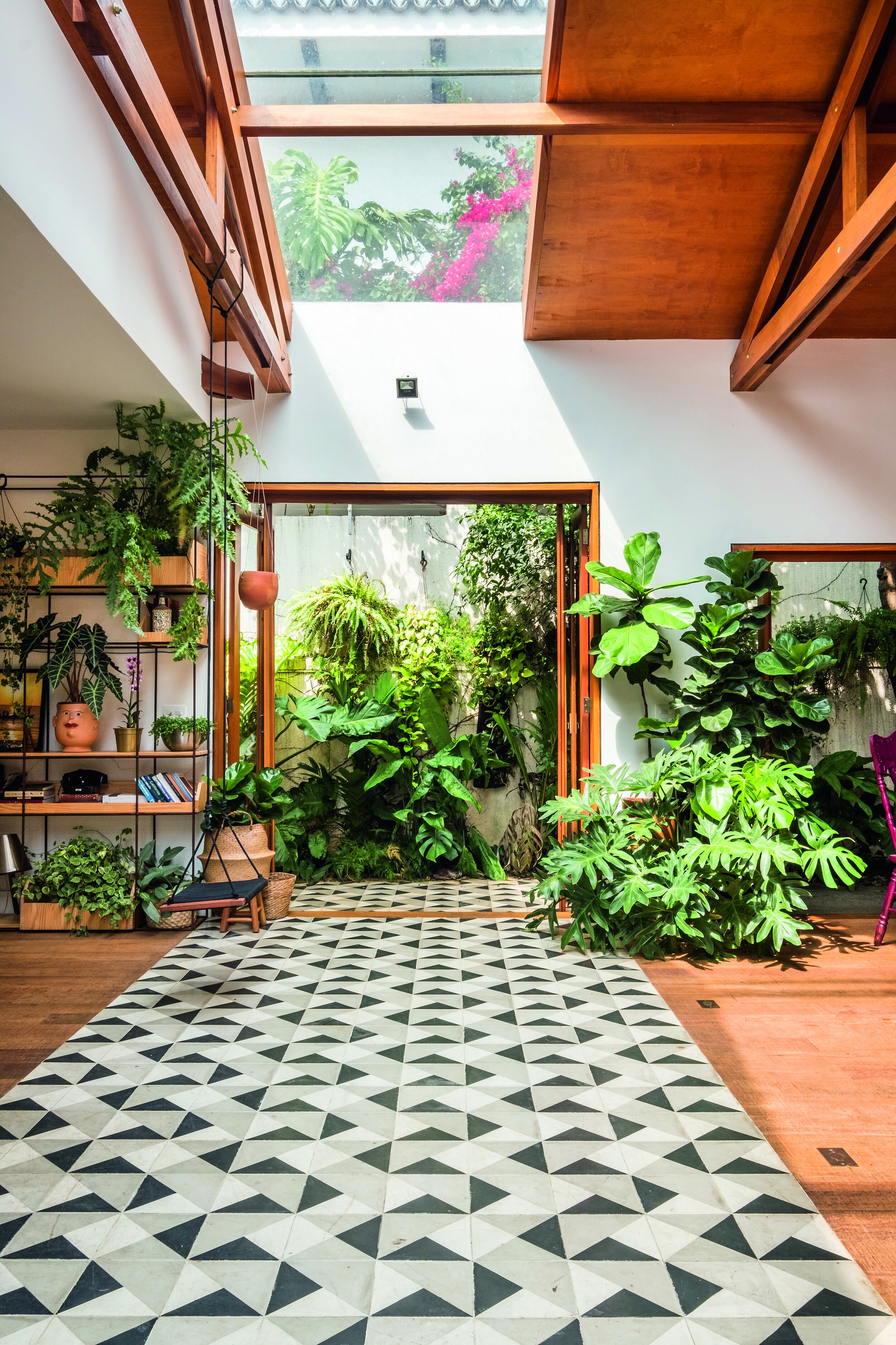 interior with geometric floor tiles and lots of greenery both inside and out