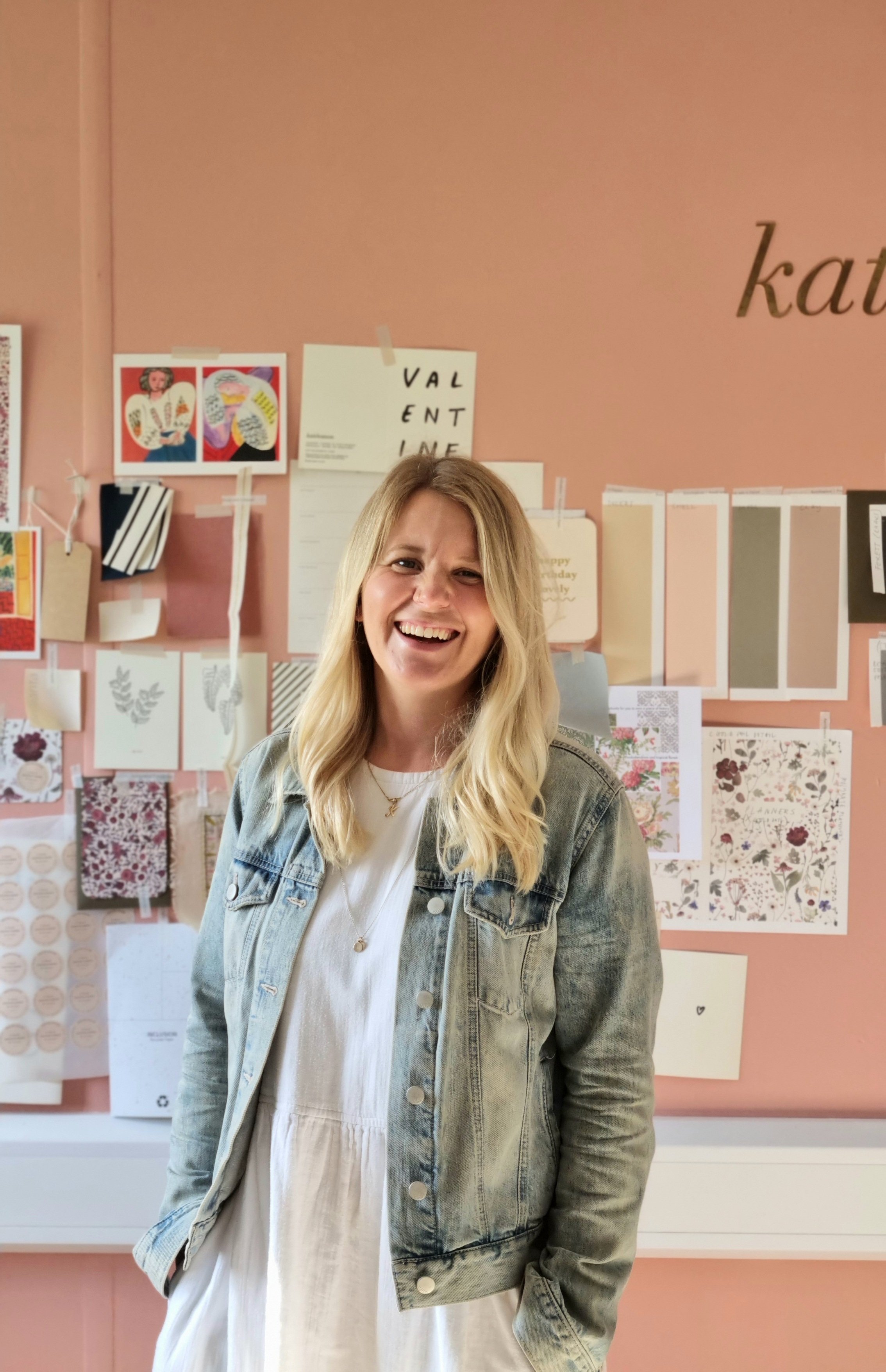 portrait of stationery designer Katie Leamon in front of moodboard