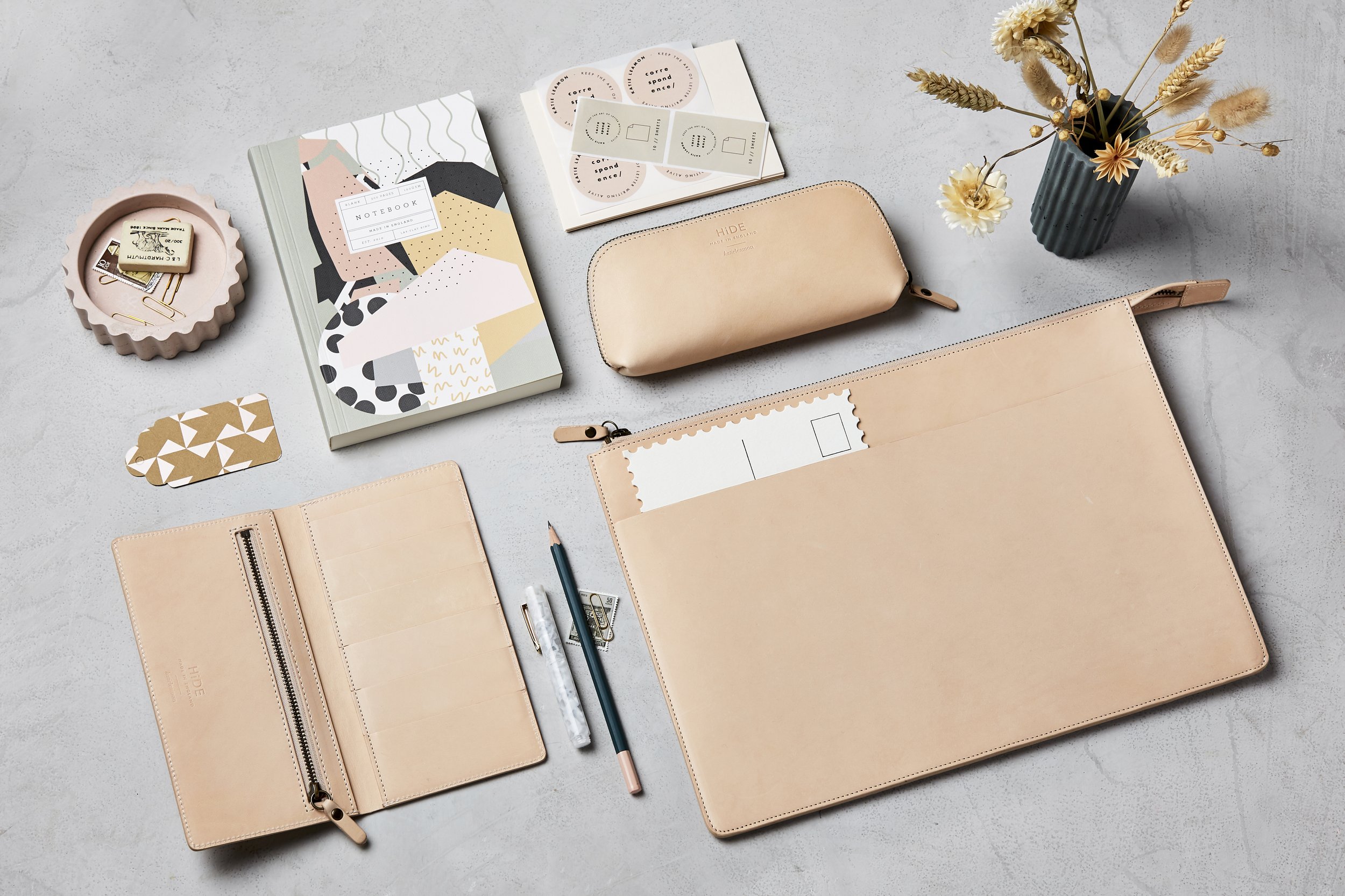 collection of luxury stationery on grey table top.