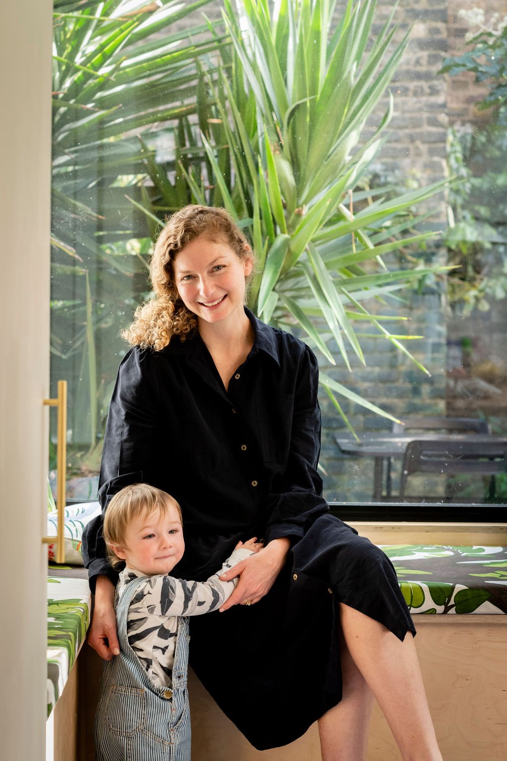Stylist Sarah Bagner with son in front of window