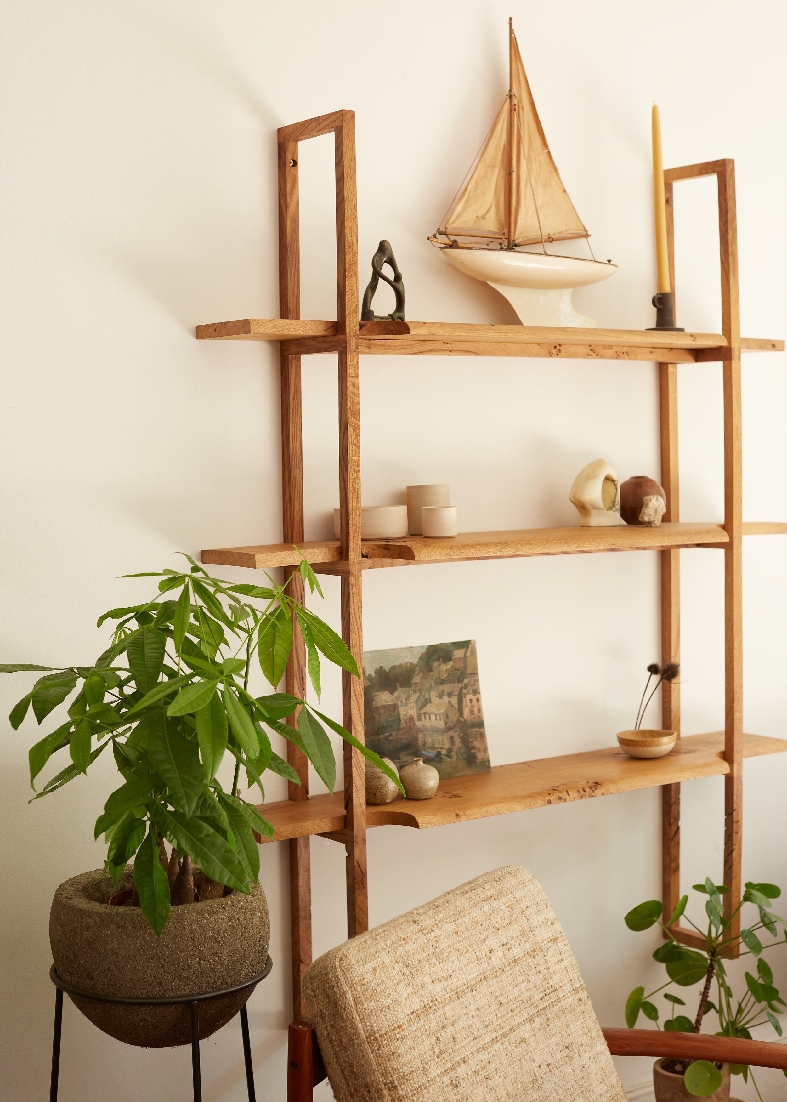 Modern wooden shelving with vintage and handmade objects