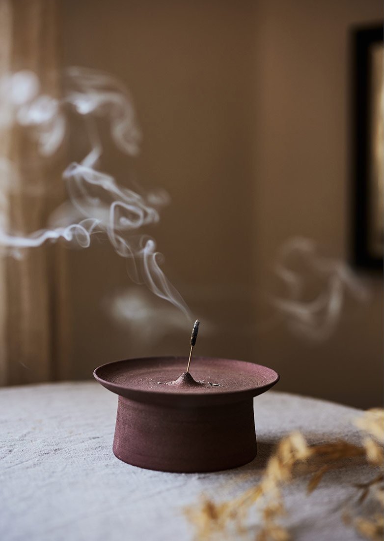 incense stick burning in a holder