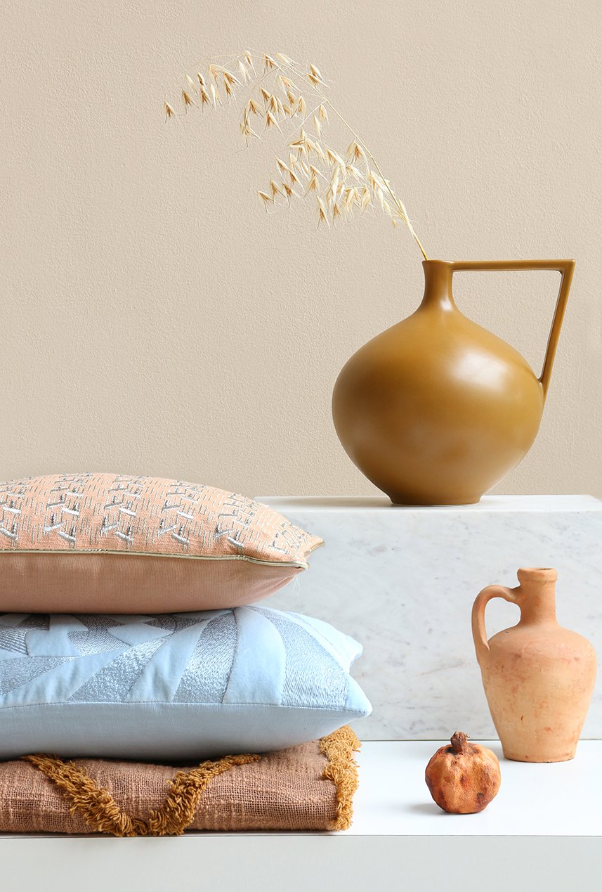 Mustard coloured vase with cushions