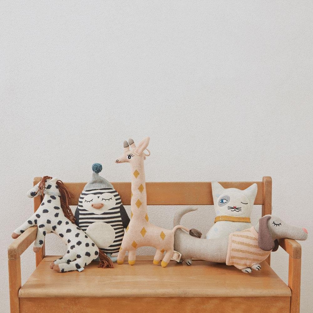 a ollection of knitted soft toy animals on a bench