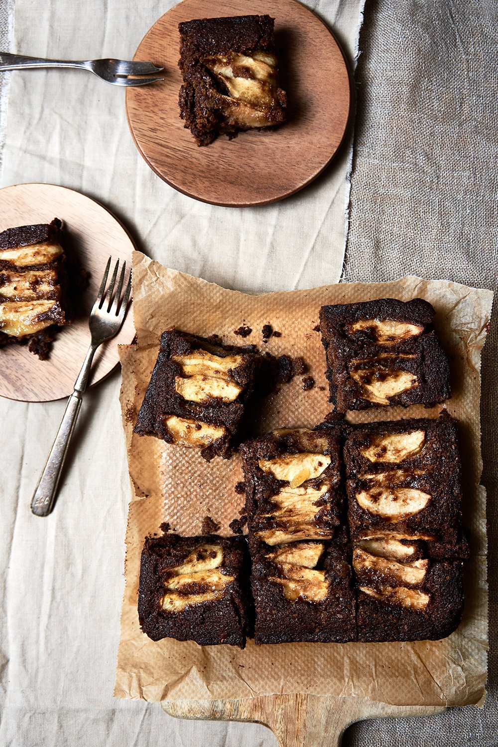 Ginger Apple & Chocolate traybake, photographed from above on plates and a wooden board