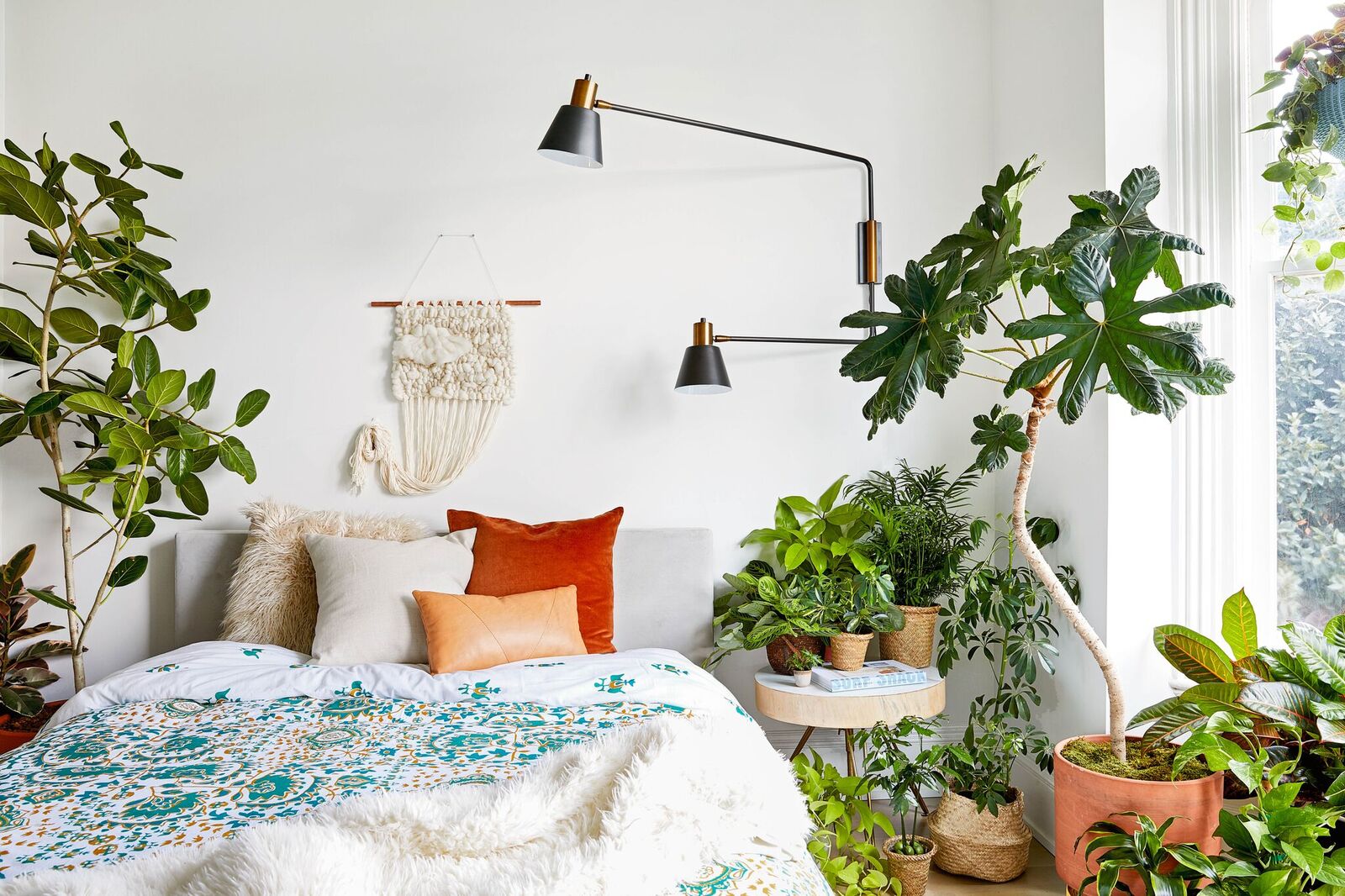 Bedroom decorated with lots of houseplants