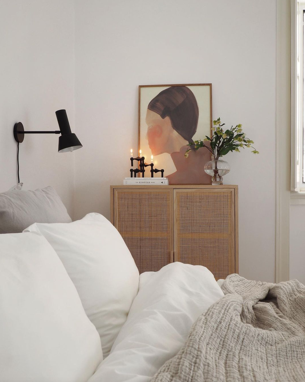 Light and airy Scandi style bedroom with artwork and candles