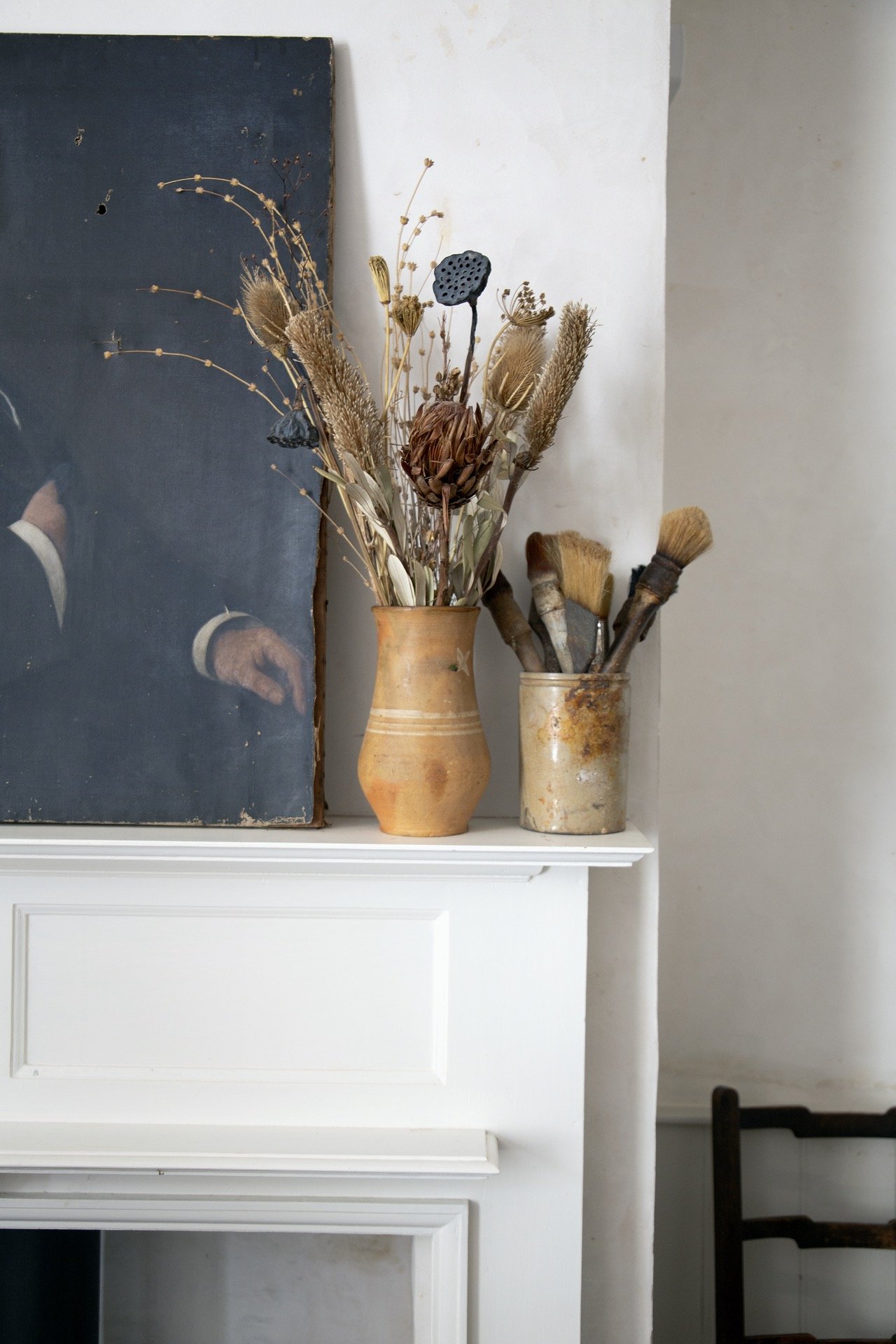 Vase of dried flowers on mantlepiece