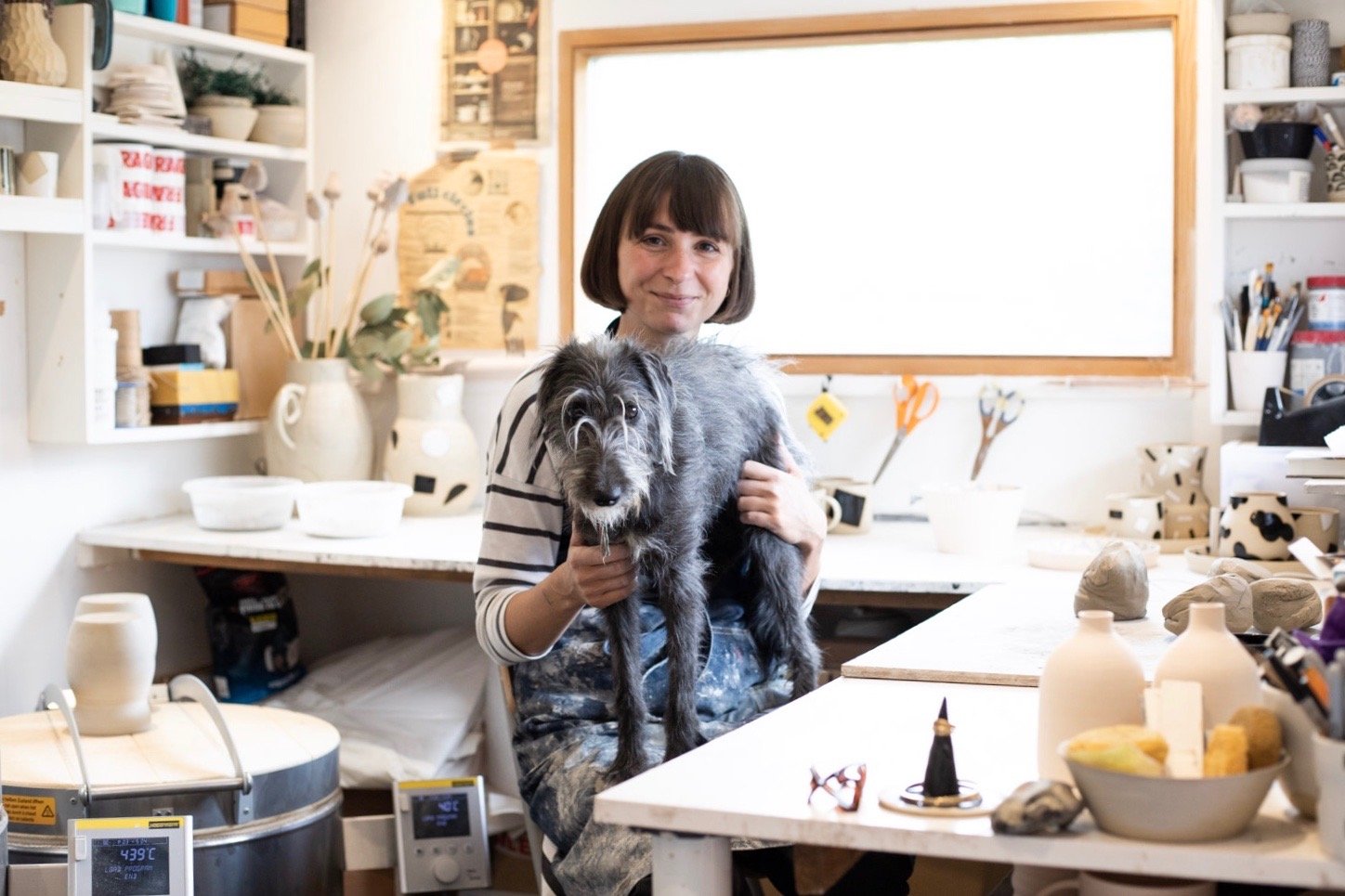 Ceramicist Hannah Bould with her dog in her studio