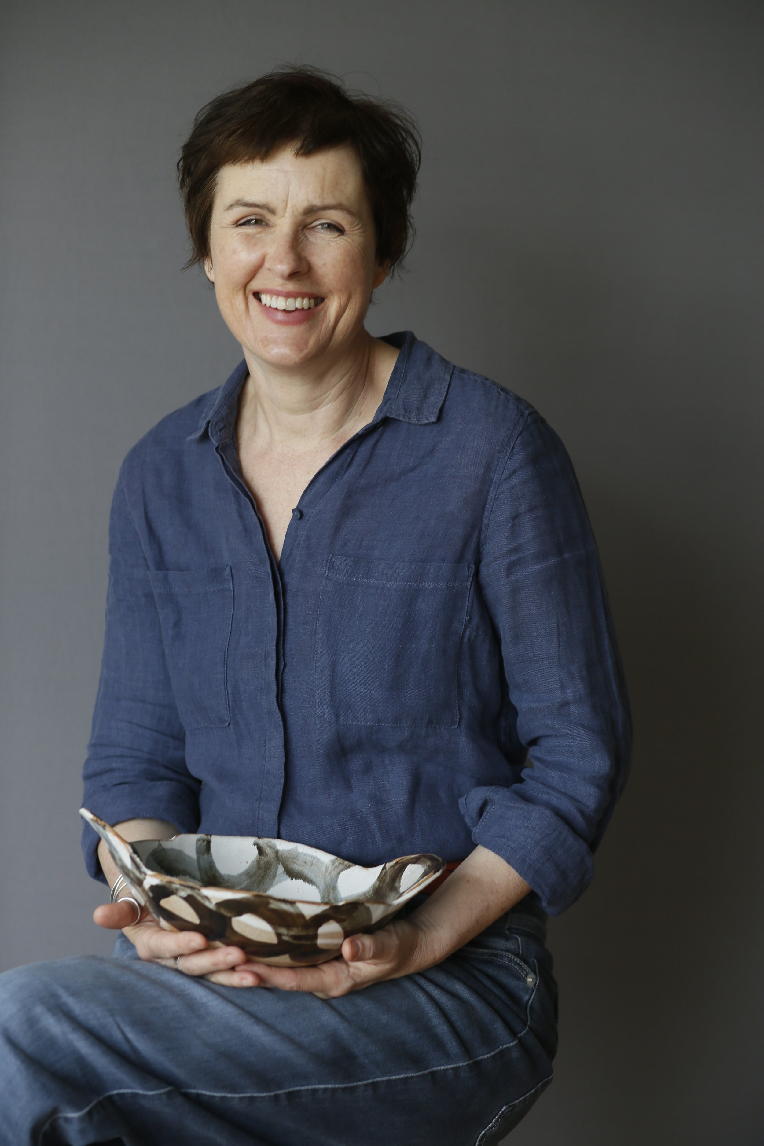 Ceramicist Nicola Gillis holding one of her own designs