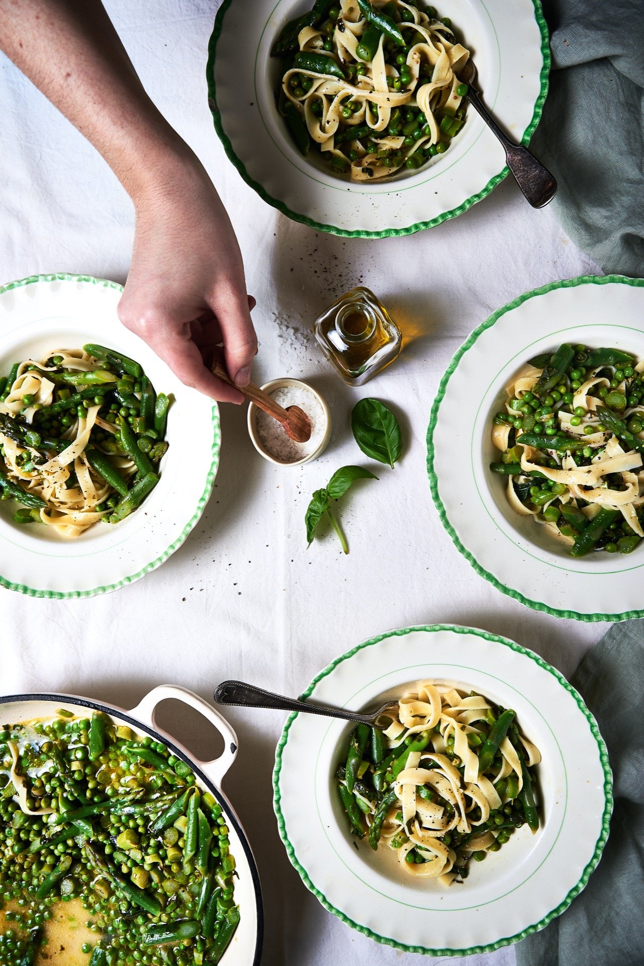 Ceramic bowls filled with asparagus and pea tagliatelle