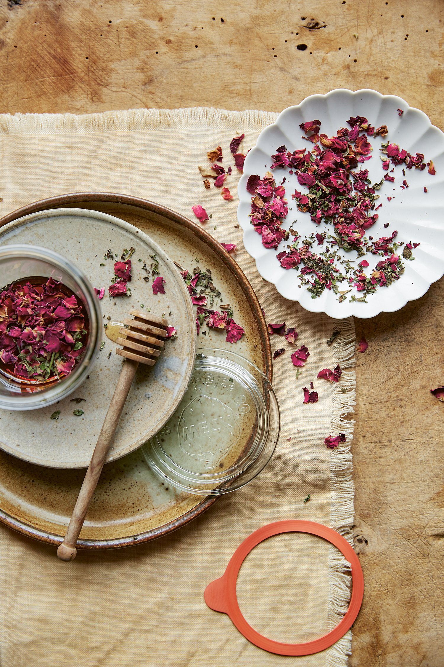 dried rose petals and lemon balm on rustic ceramic plates