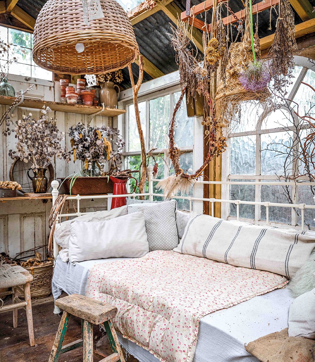 interior of reclaimed greenhouse filled with vintage things and dried flowers