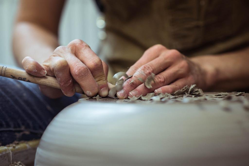 Maker Katie Coston of Illyria Pottery trims her homemade ceramics
