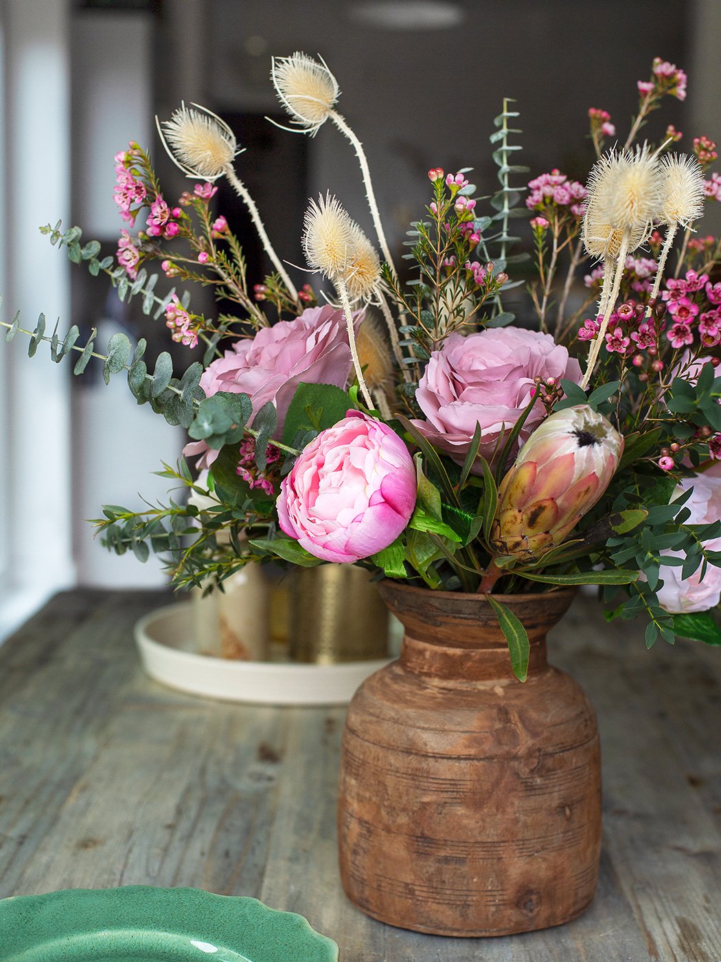 Beautiful vase of pink flowers mixed with dried flowers