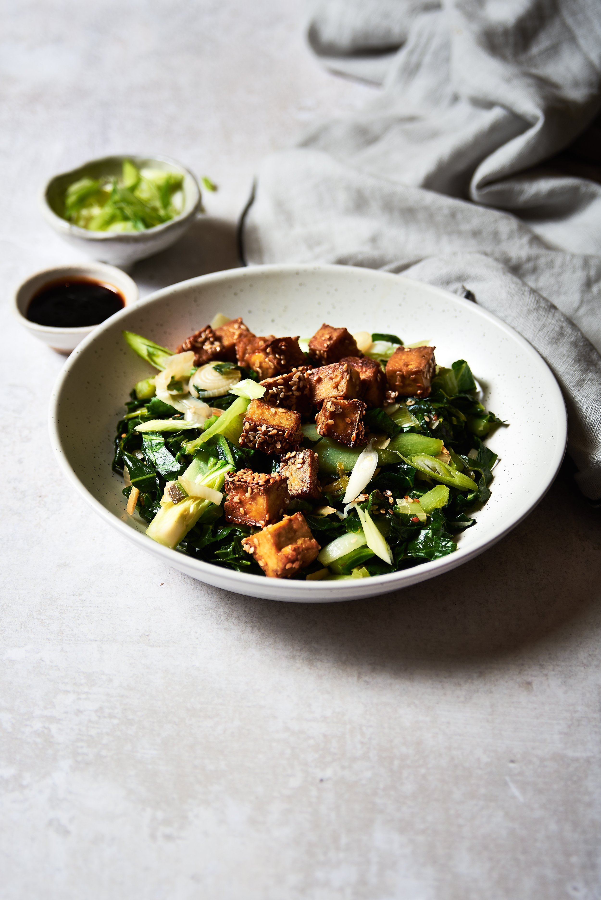 A bowl of spring greens and tofu