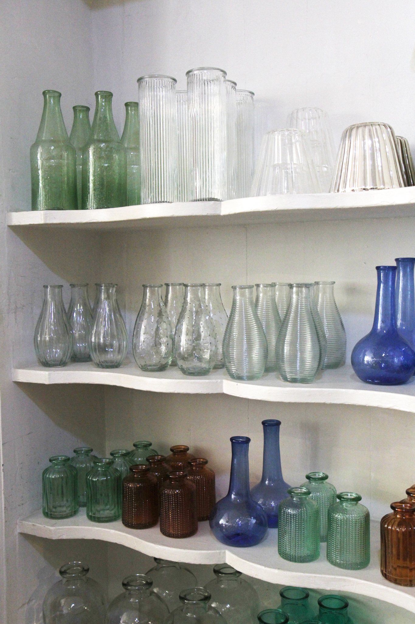 Vintage glass jars on shelves inside vintage interiors store Domestic Science