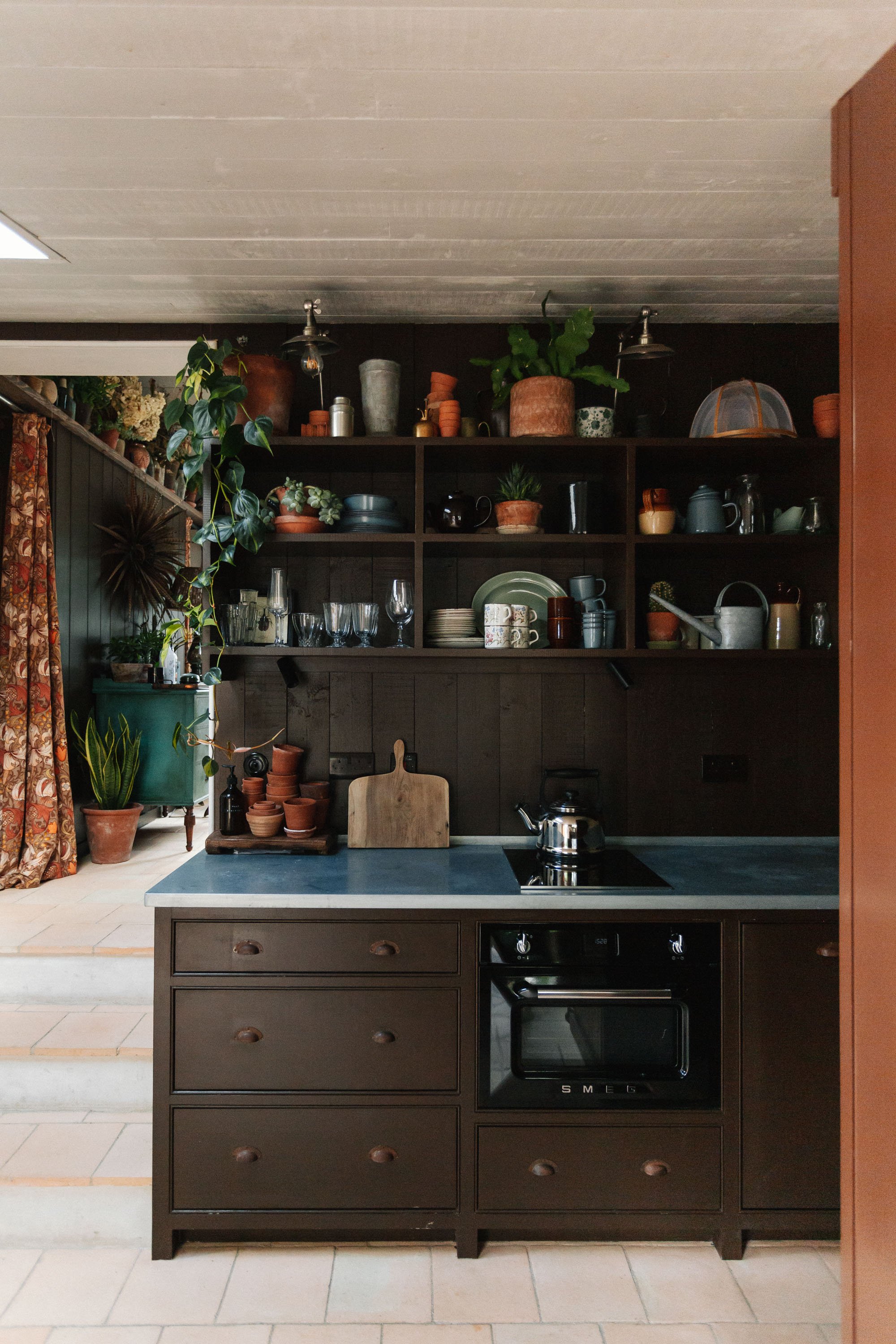 kitchen with open shelving, painted in dark brown