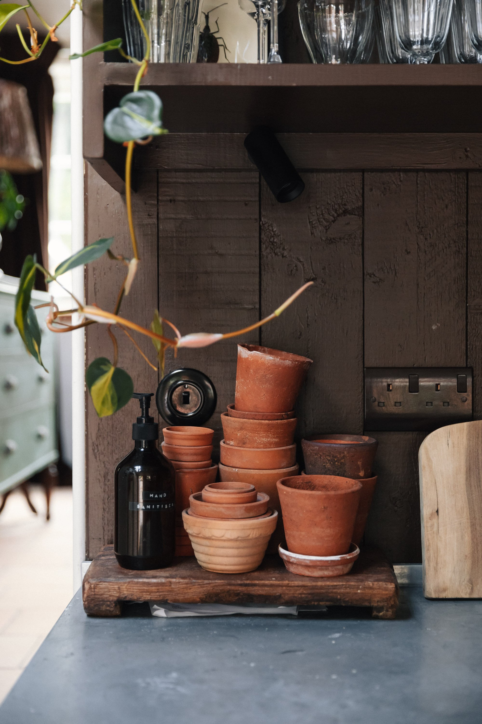 a collection of old terracotta plant pots on a kitchen worktop