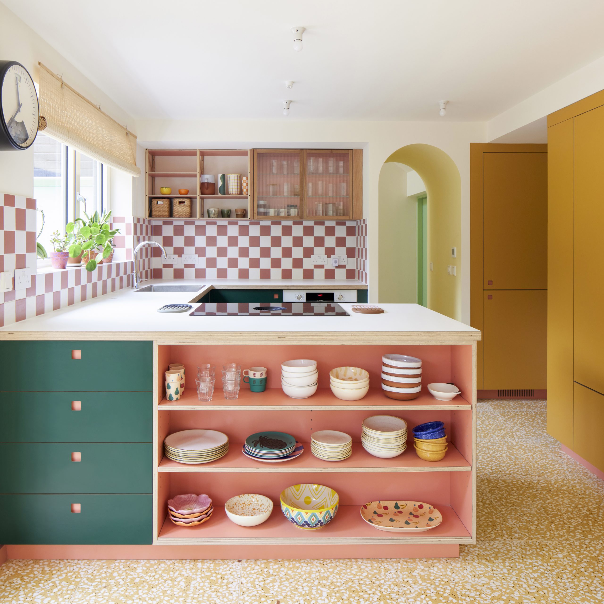 Pink kitchen with green and mustard accents by independent kitchen designers Pluck