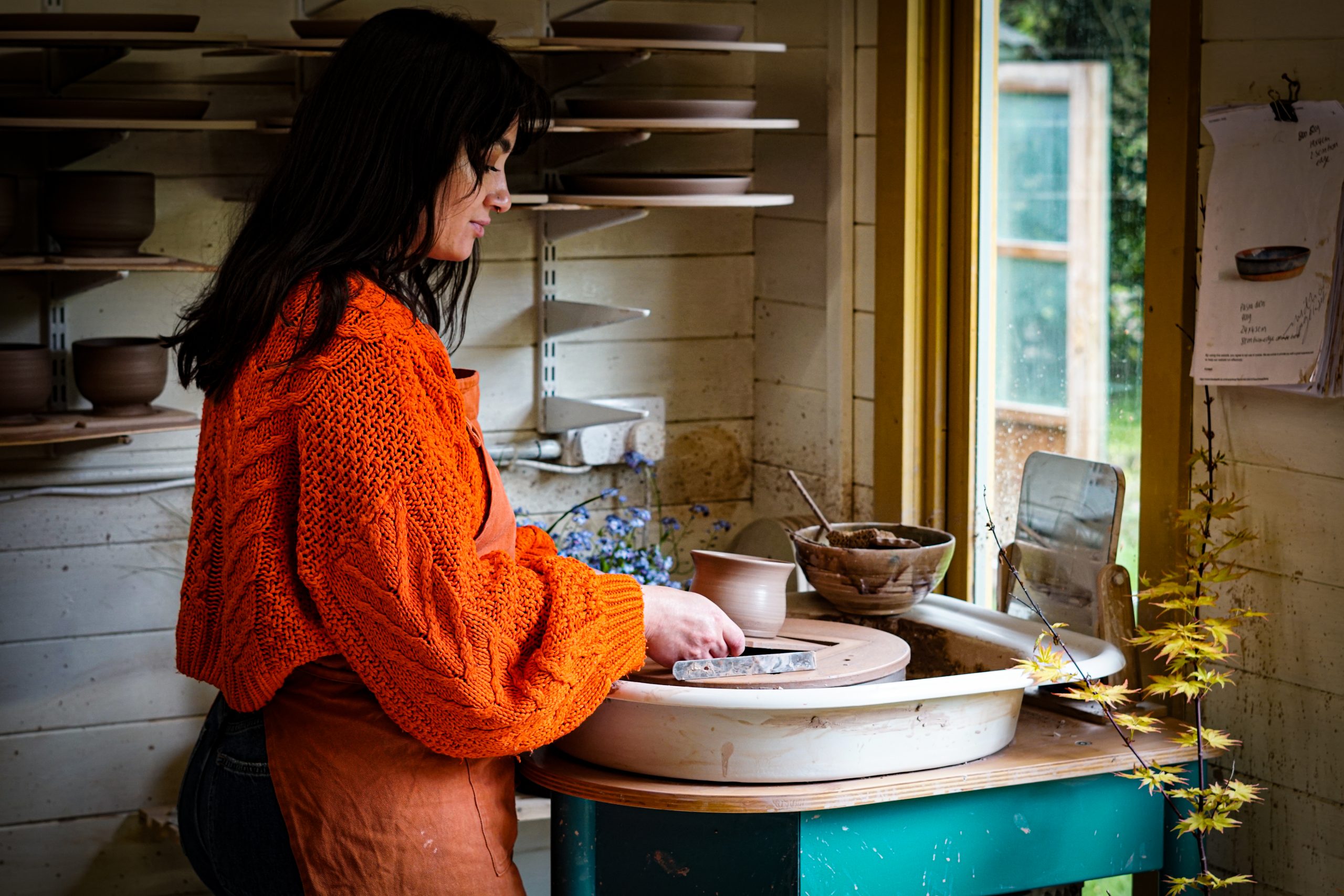 Supatra Marsh of Blank Earth Ceramics creating ceramics on the pottery wheel in her Suffolk studio