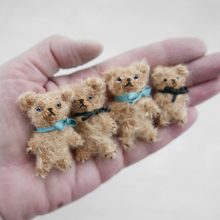 Mini handmade bears by modflowers inside maker's hand