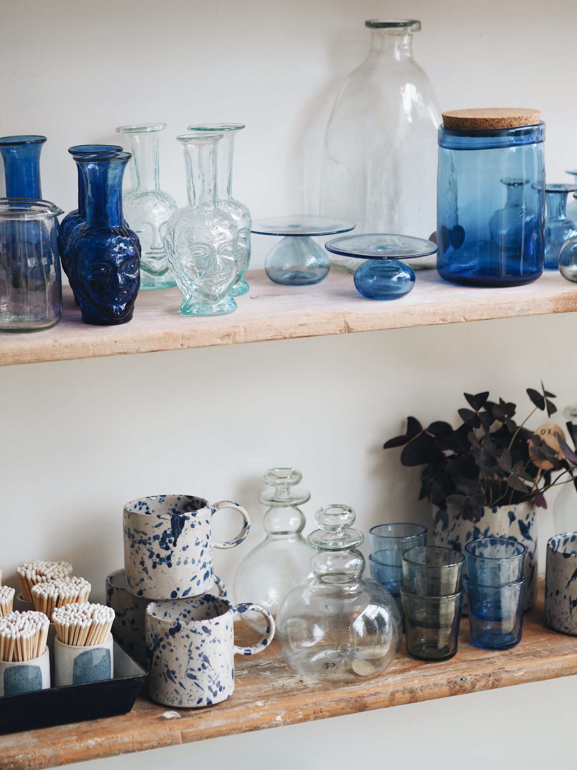 Blue glassware and ceramics inside The Botanical Candle Co. in Shaftesbury, Dorset