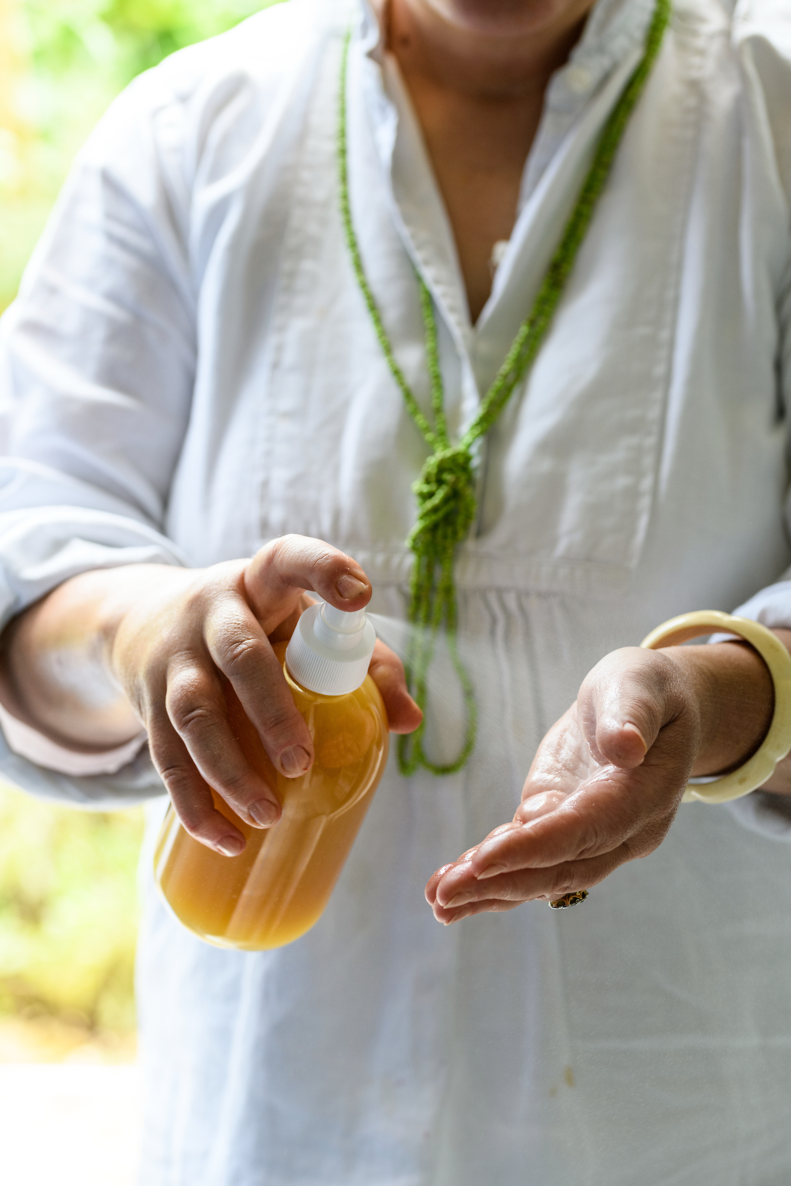 Natural skincare company owner Silvana de Soissons spraying Lemon Balm, lime and thyme flower hand sanitiser spray