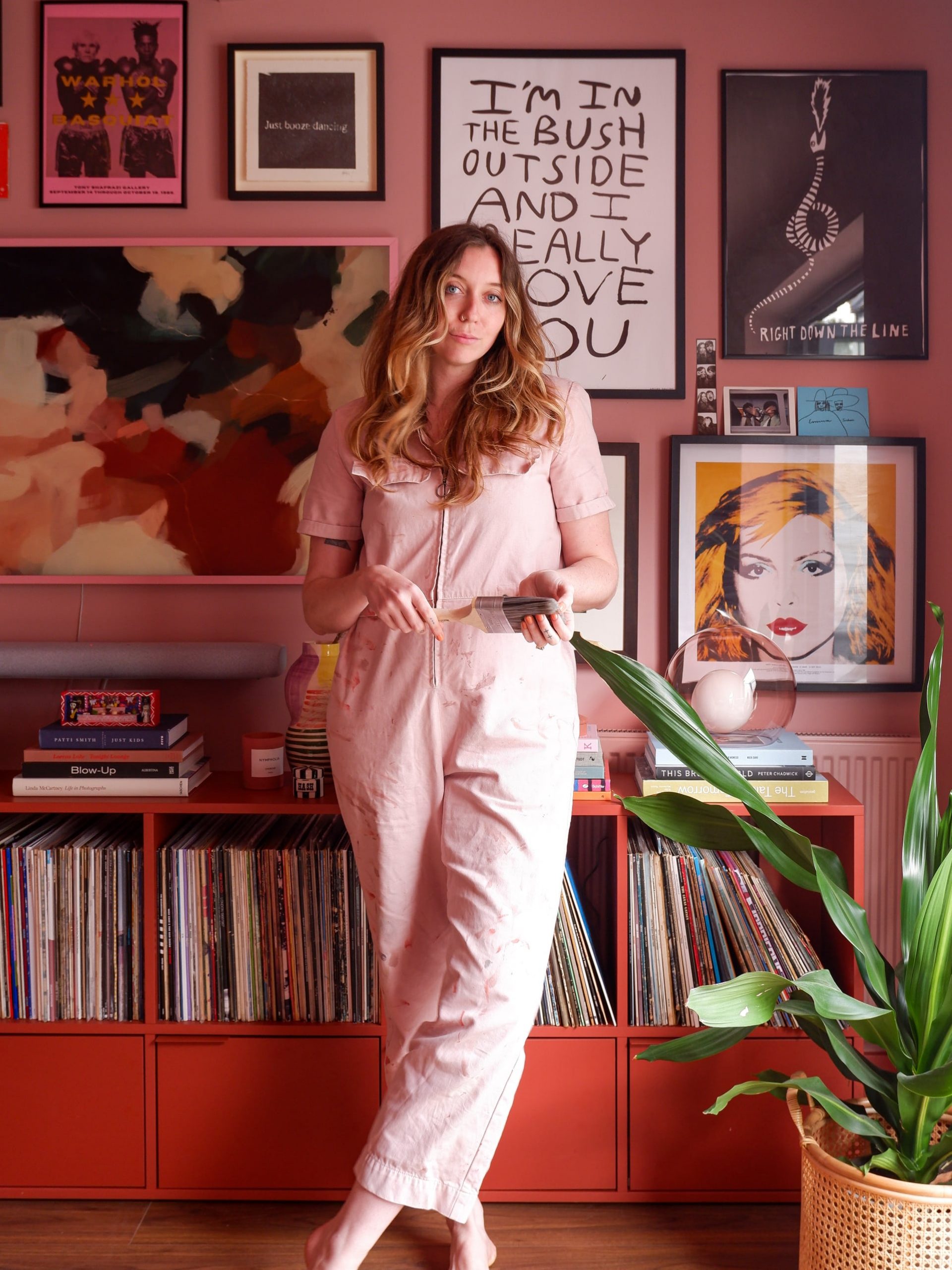 Emma Jane Palin in her pink living room with gallery wall and mid-century sideboard containing record collection