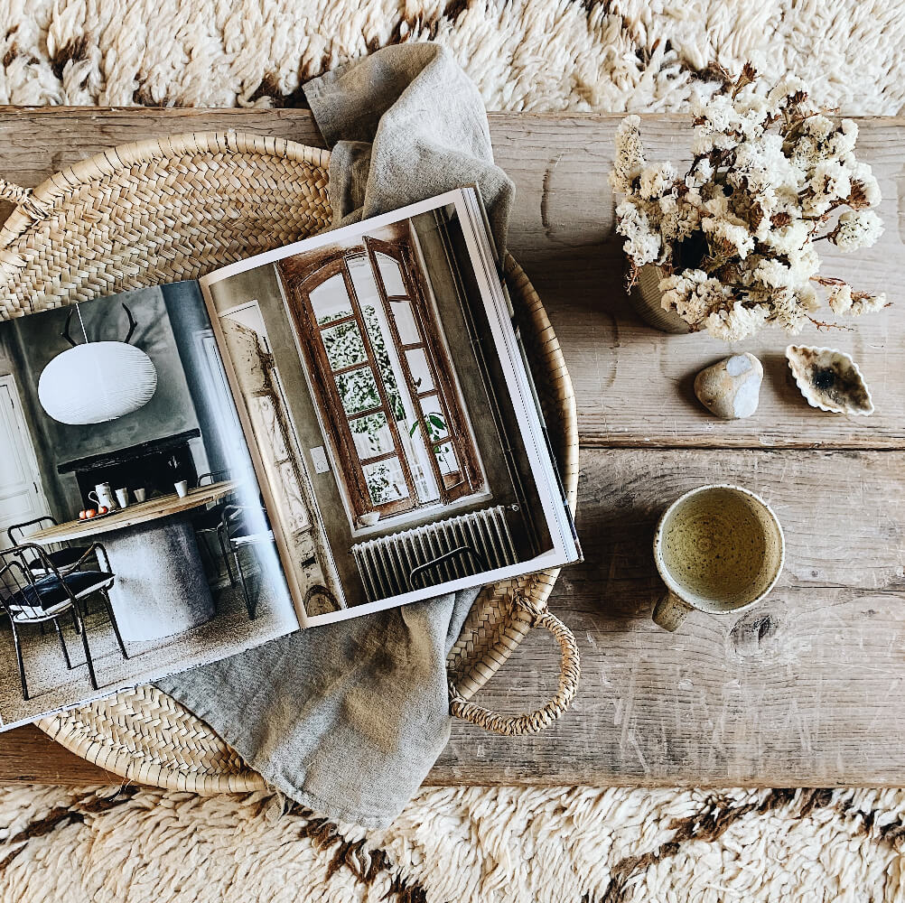 Interior magazine flat lay on bohemian wooden table taken by Jane Day of Tea With Ruby