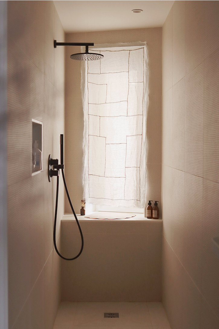 Minimal pared back shower room in pale muted colour scheme