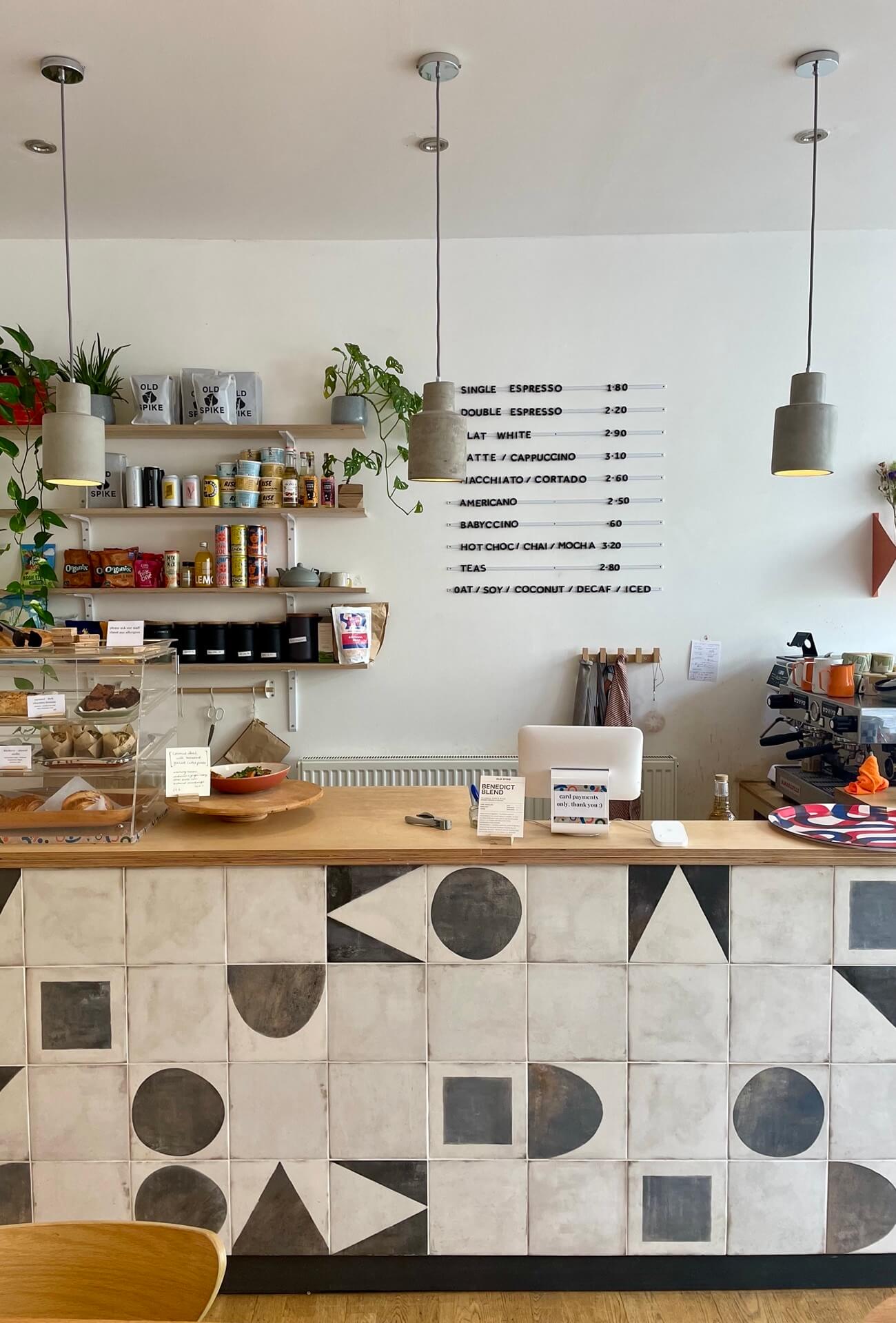The coffee bar of South London paper craft cafe Paper Stories based in Gipsy HIll. Beautiful monochorme tiles clad the front of the counter.