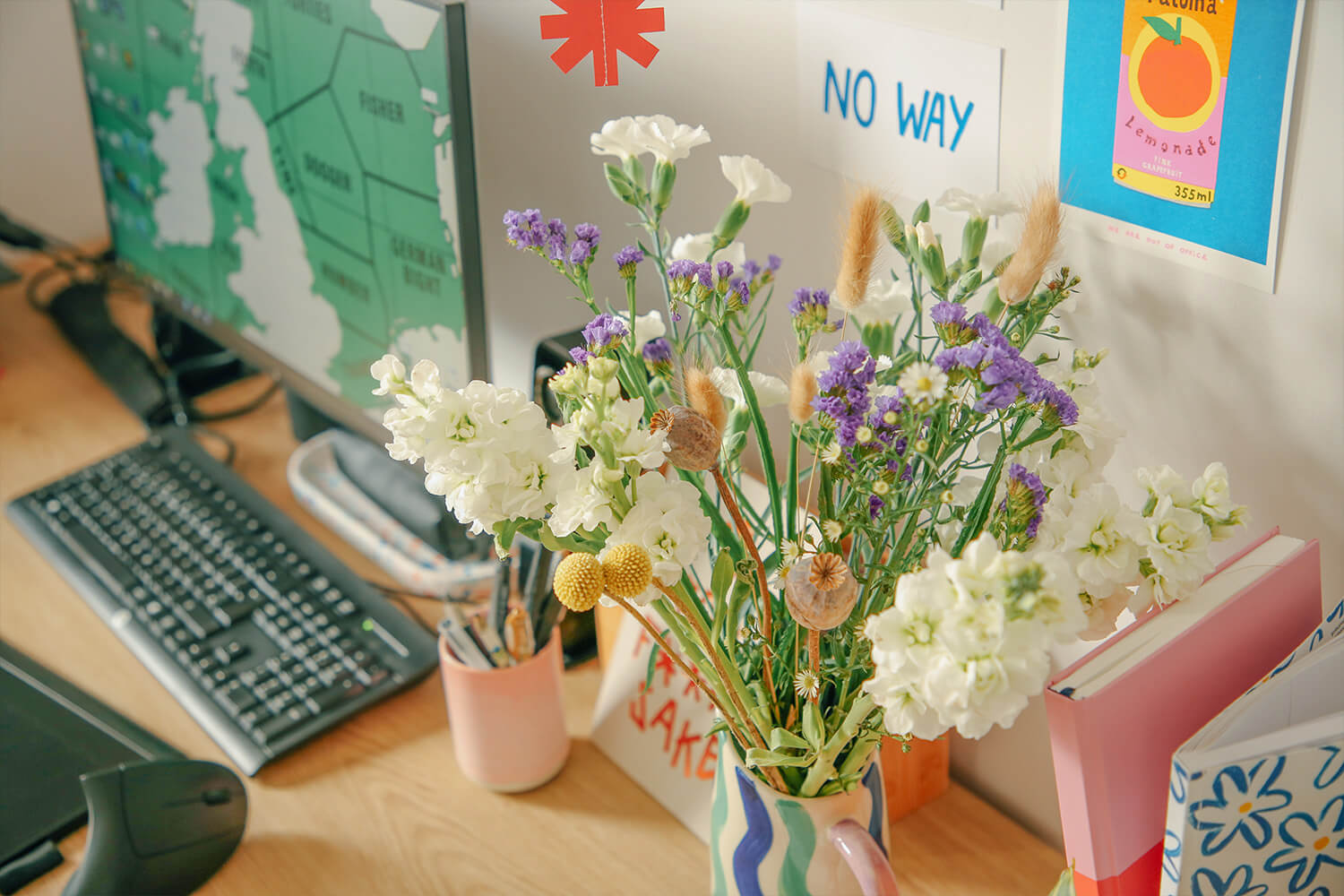 Wildflowers on the desk of illustrator and maker Taaryn Brench's colourful studio