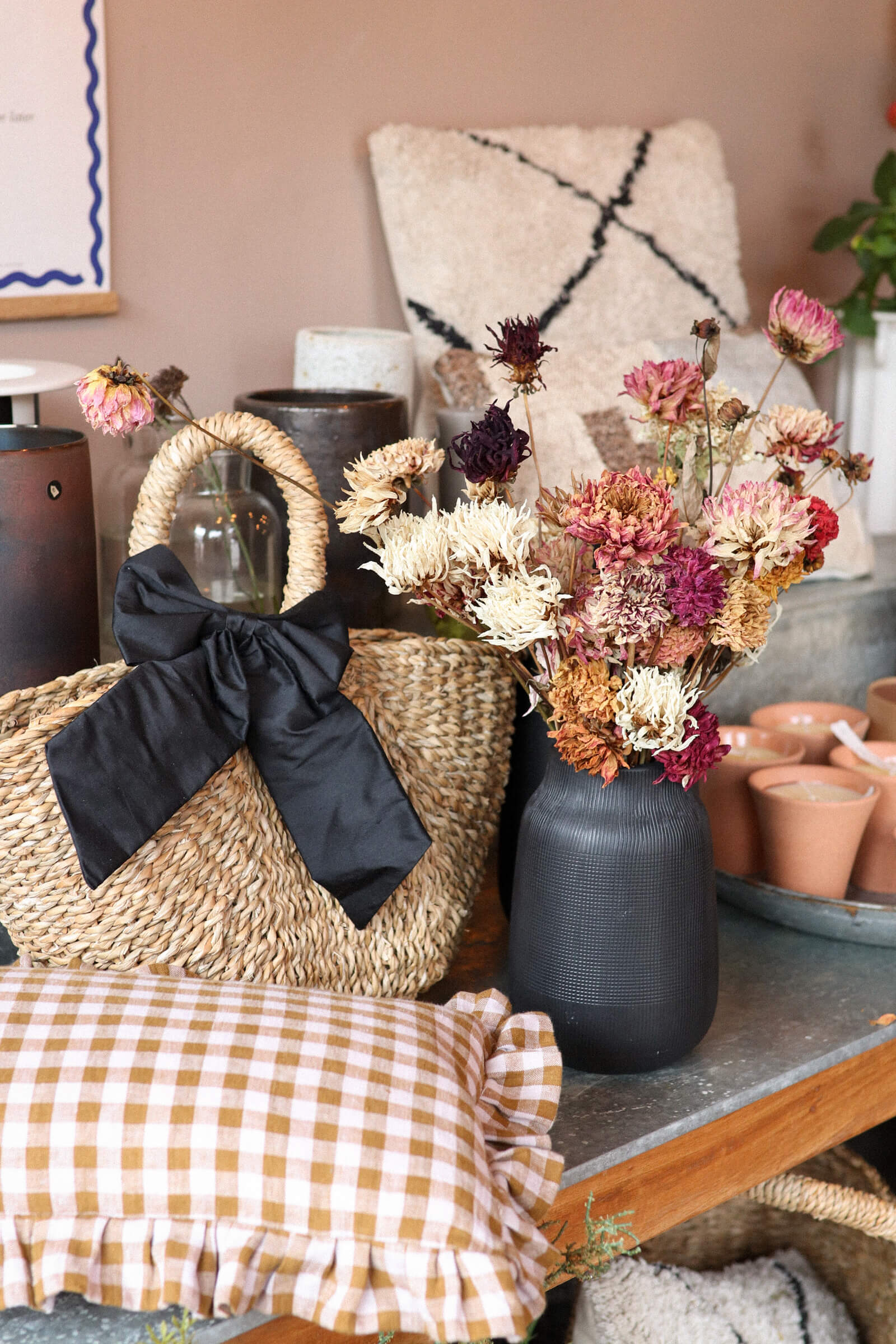 Bohemian interiors and homeware including gingham cushion, dried flowers and wicker bag inside independent flower shop Hedge, Birmingham