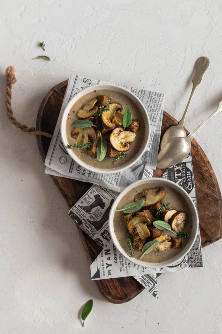 bowls of mushroom soup on wooden board