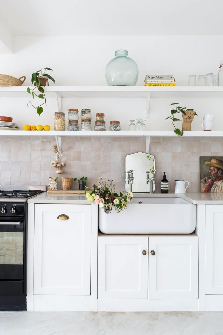 White kitchen with open shelving styled with vintage finds