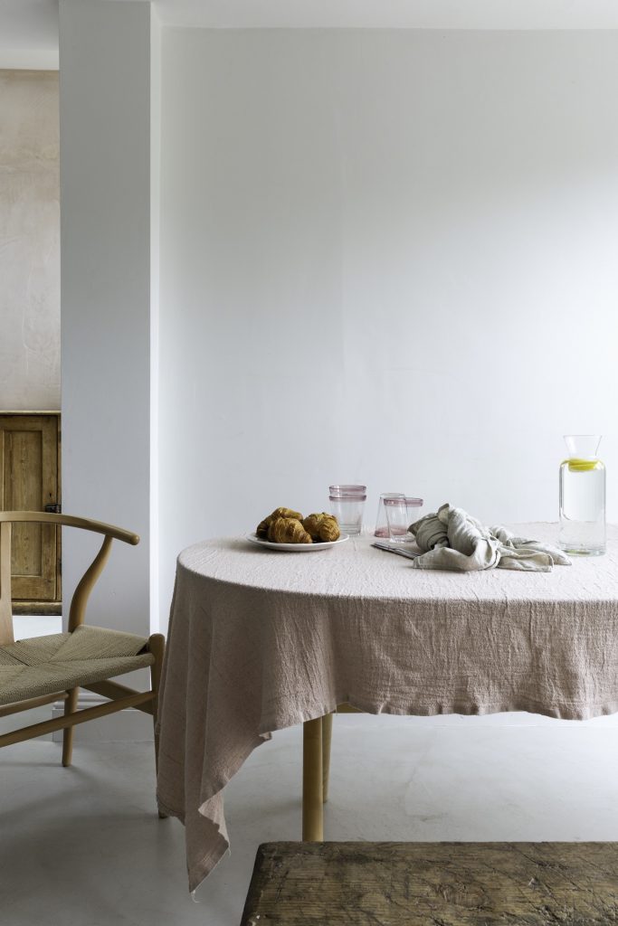 Dining table with pink linen table cloth