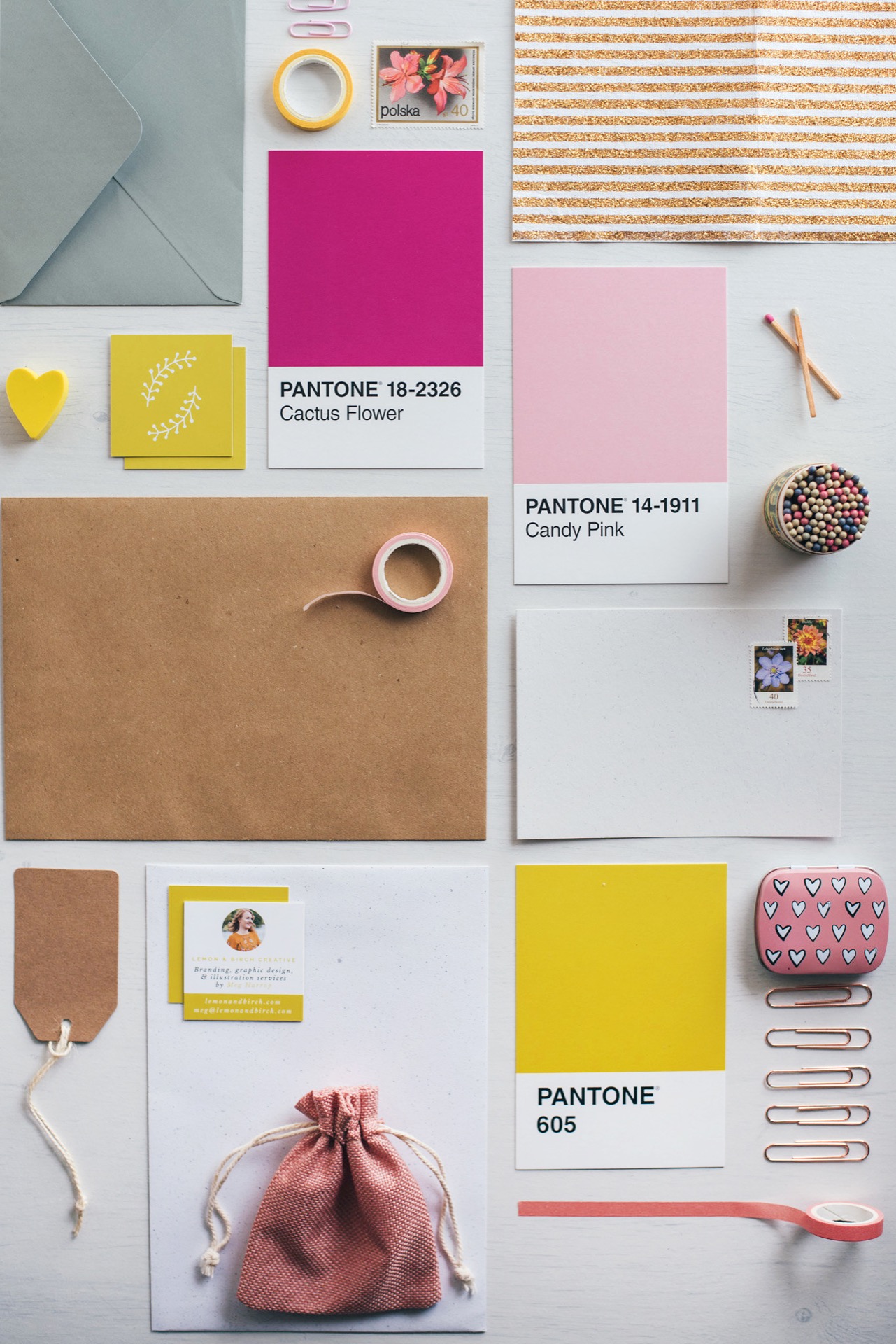 a flat lay of different paper goods including Pantone colour cards