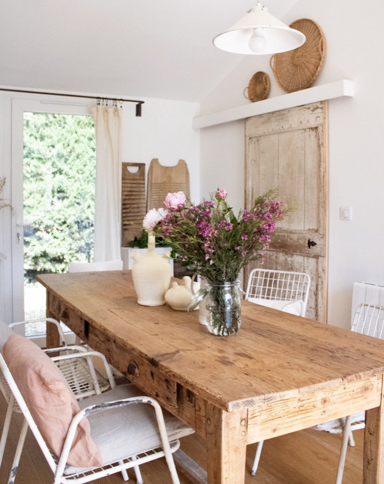 large wooden vintage dining table in a bright French home