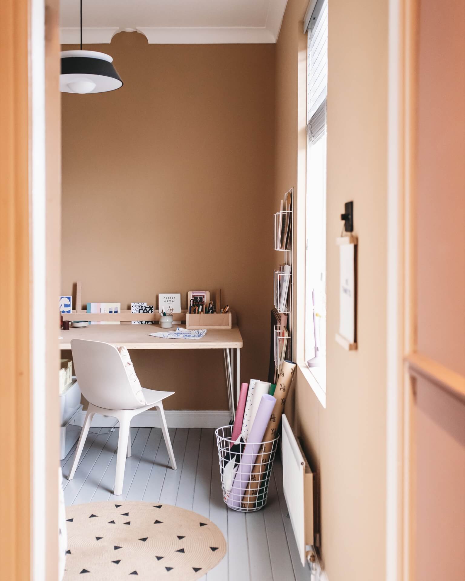Peach coloured walls in the creative home studio of illustrator Abbey Withington