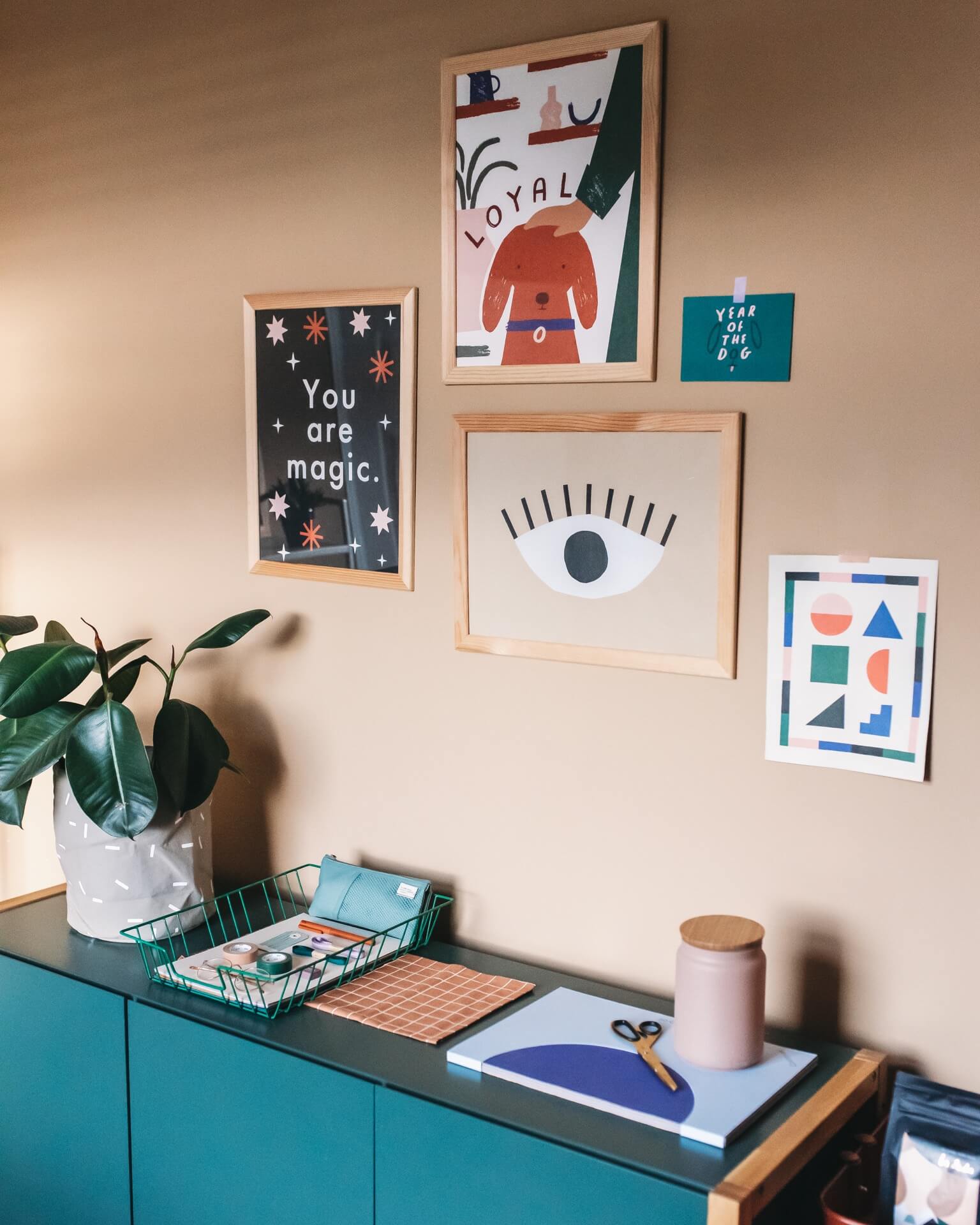 Peach coloured walls and artwork in the creative home studio of illustrator Abbey Withington