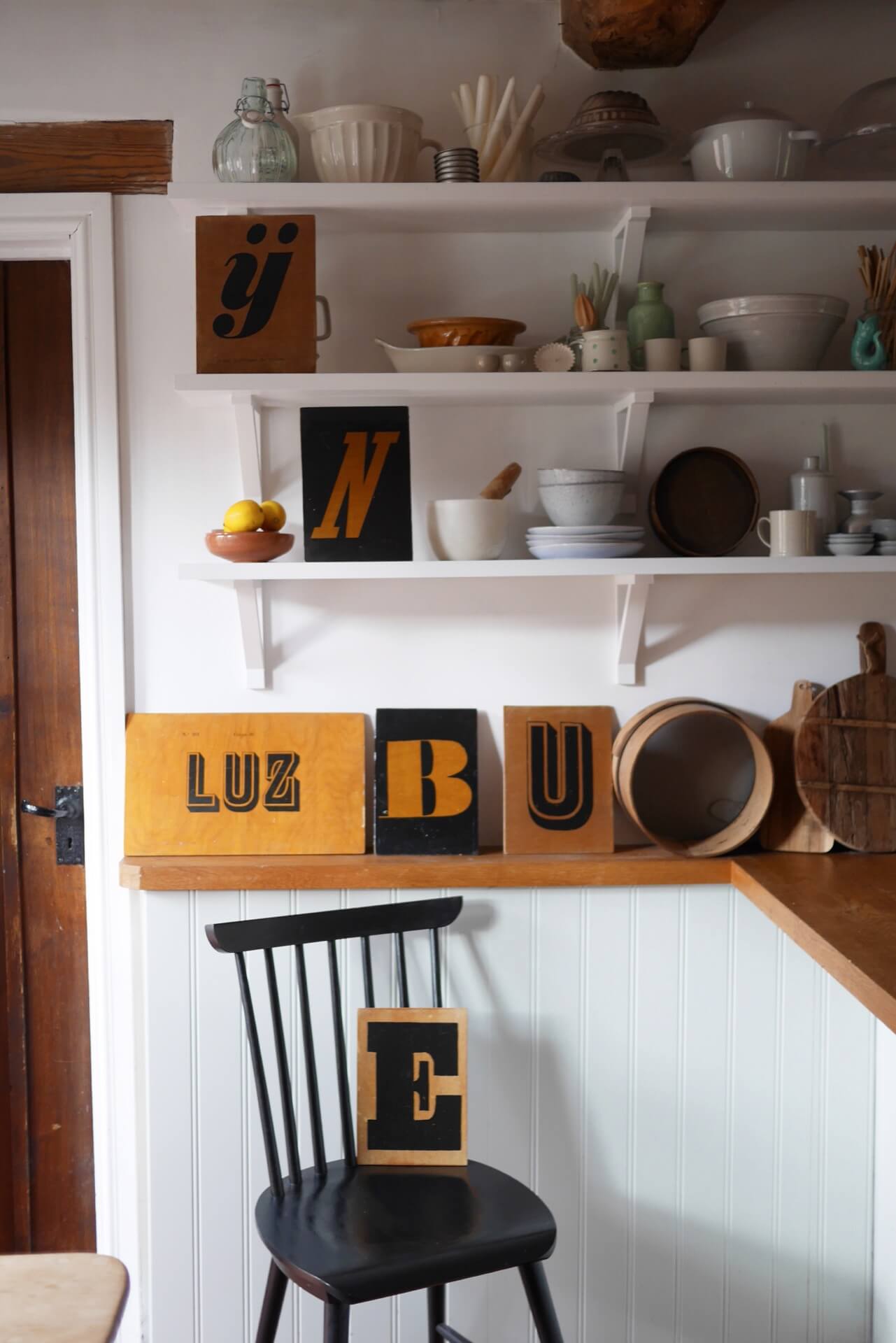 Opening shelving in the kitchen styled with ceramics and vintage finds. home of Laura Jenkinson of Ticking Stripe Home