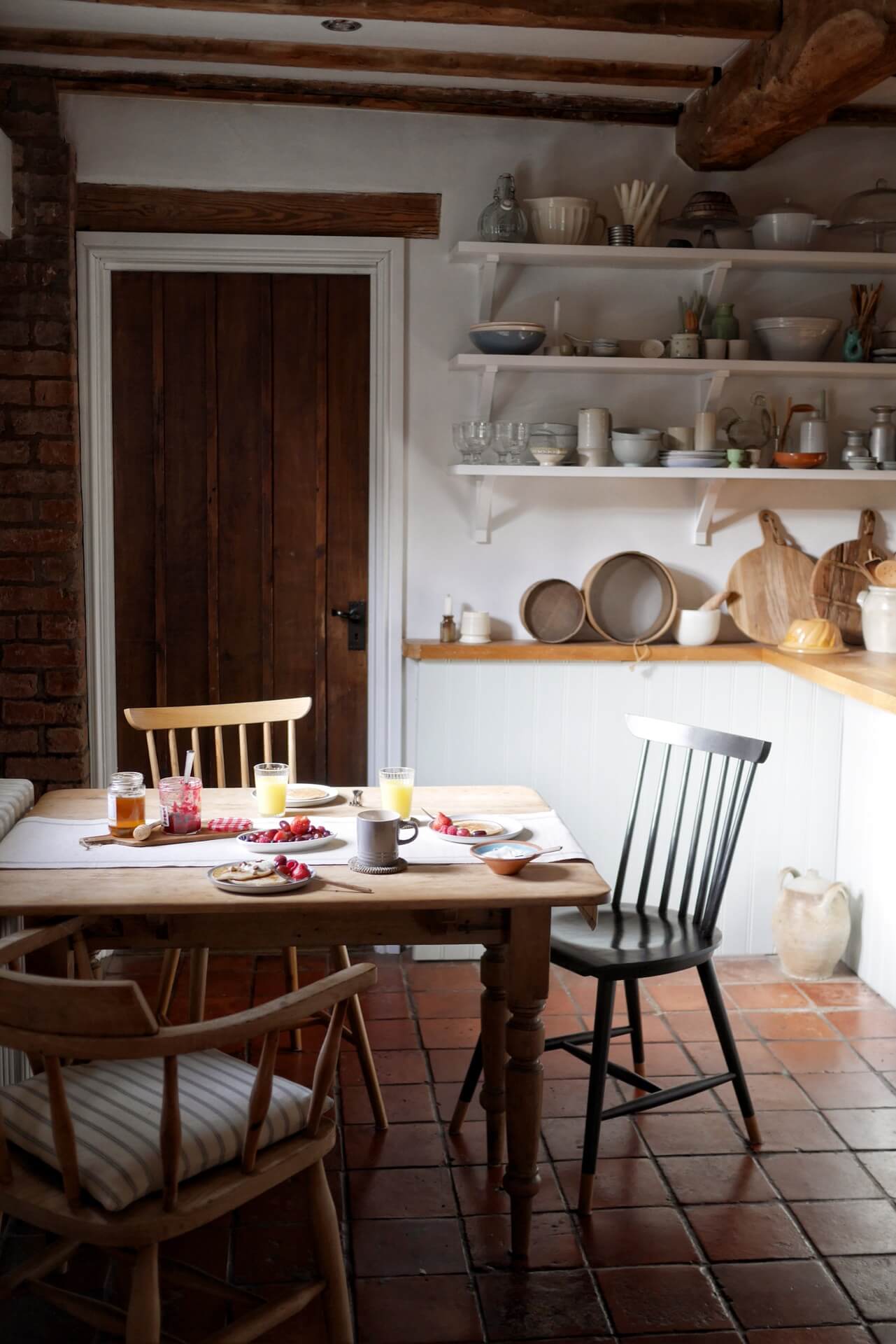 kitchen table laid for breakfast in a period home kitchen. home of Laura Jenkinson of Ticking Stripe Home