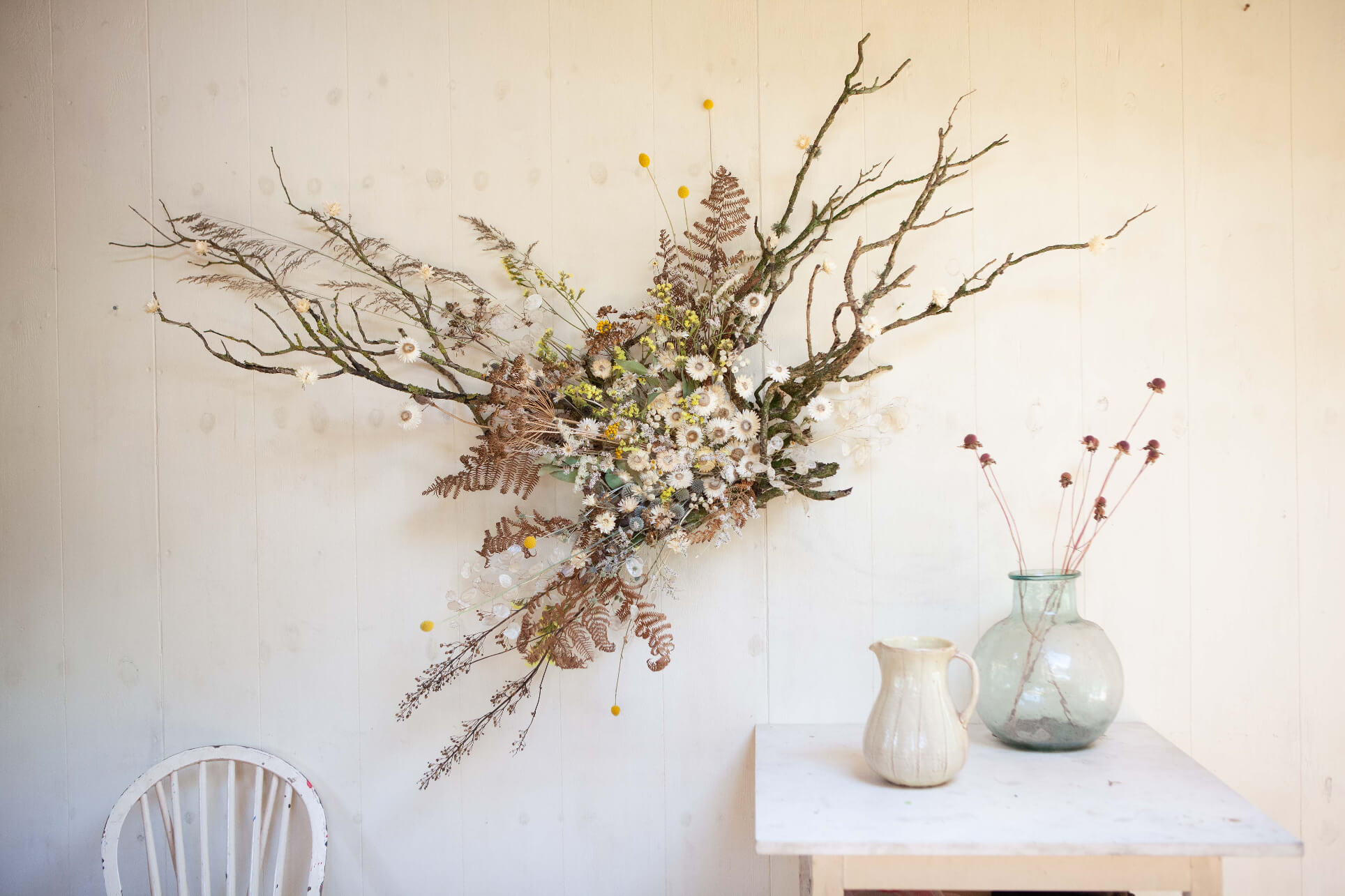 A neutral dried flower display by sustainable interior floral sculpture designer Layla Robinson