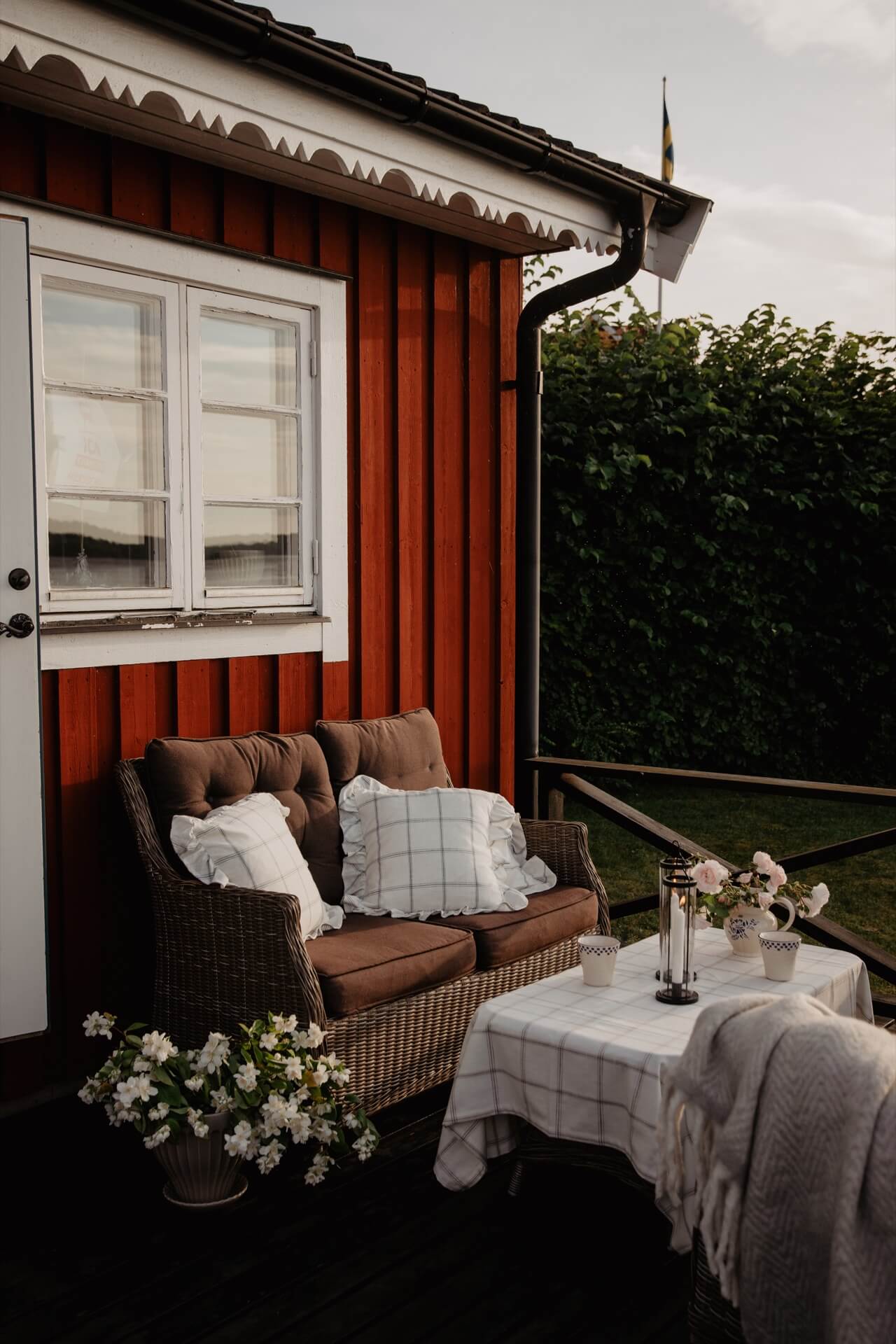 Emelie Sundberg home tour - exterior of Swedish home with cosy seating area.